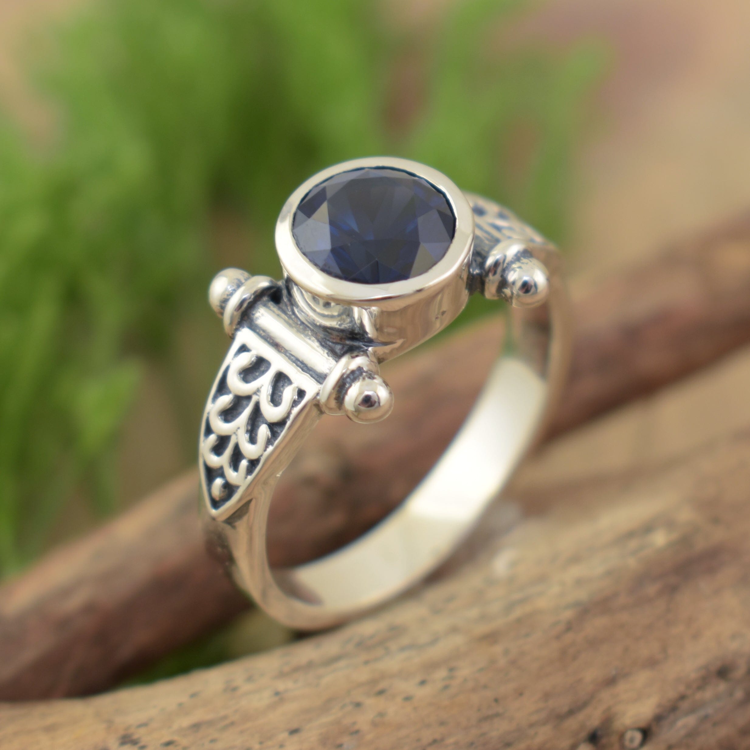 thin sterling silver band featuring bezel set sapphire blue cz