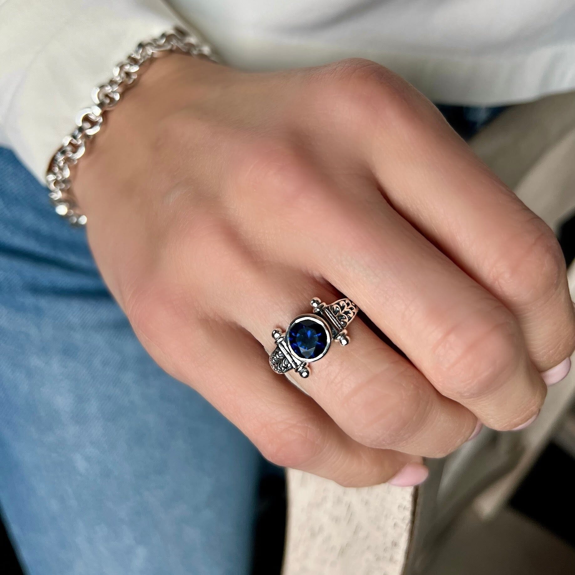 sterling silver ring with a bezel set blue CZ stone.