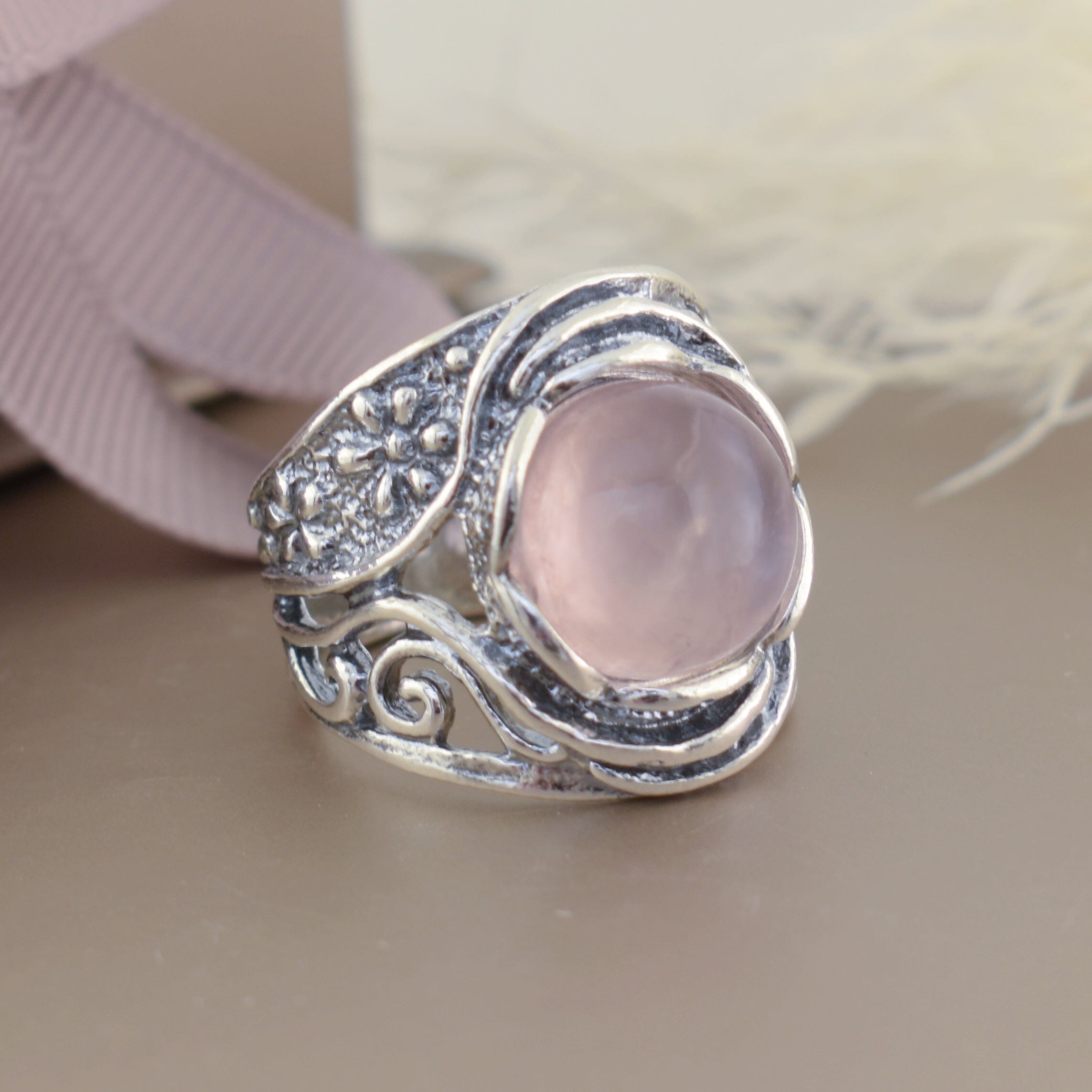 chunky designer ring in sterling silver with bezel set rose quartz center