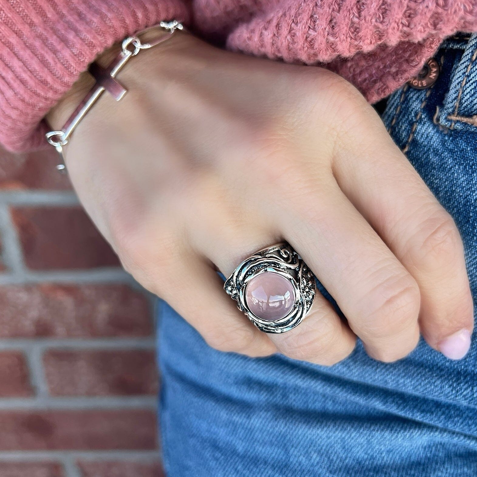 sterling silver ring with flower designs on band, featuring a rose quart stone