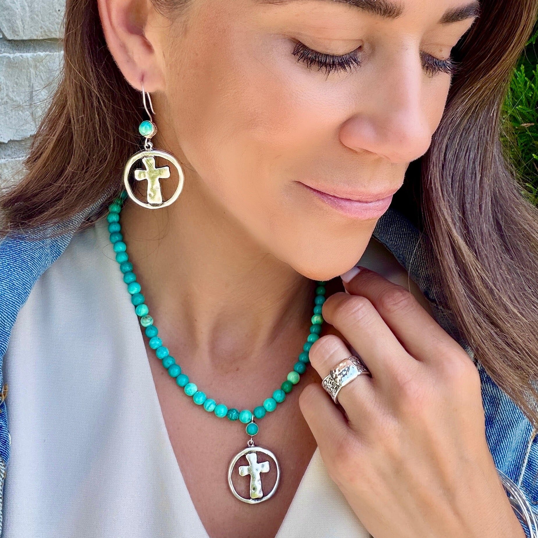 reconstruced turquoise earrings with a large cross dangle
