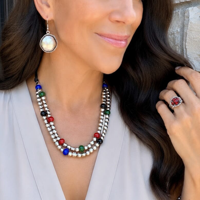 silver beaded necklace with red, green, blue, and black stones