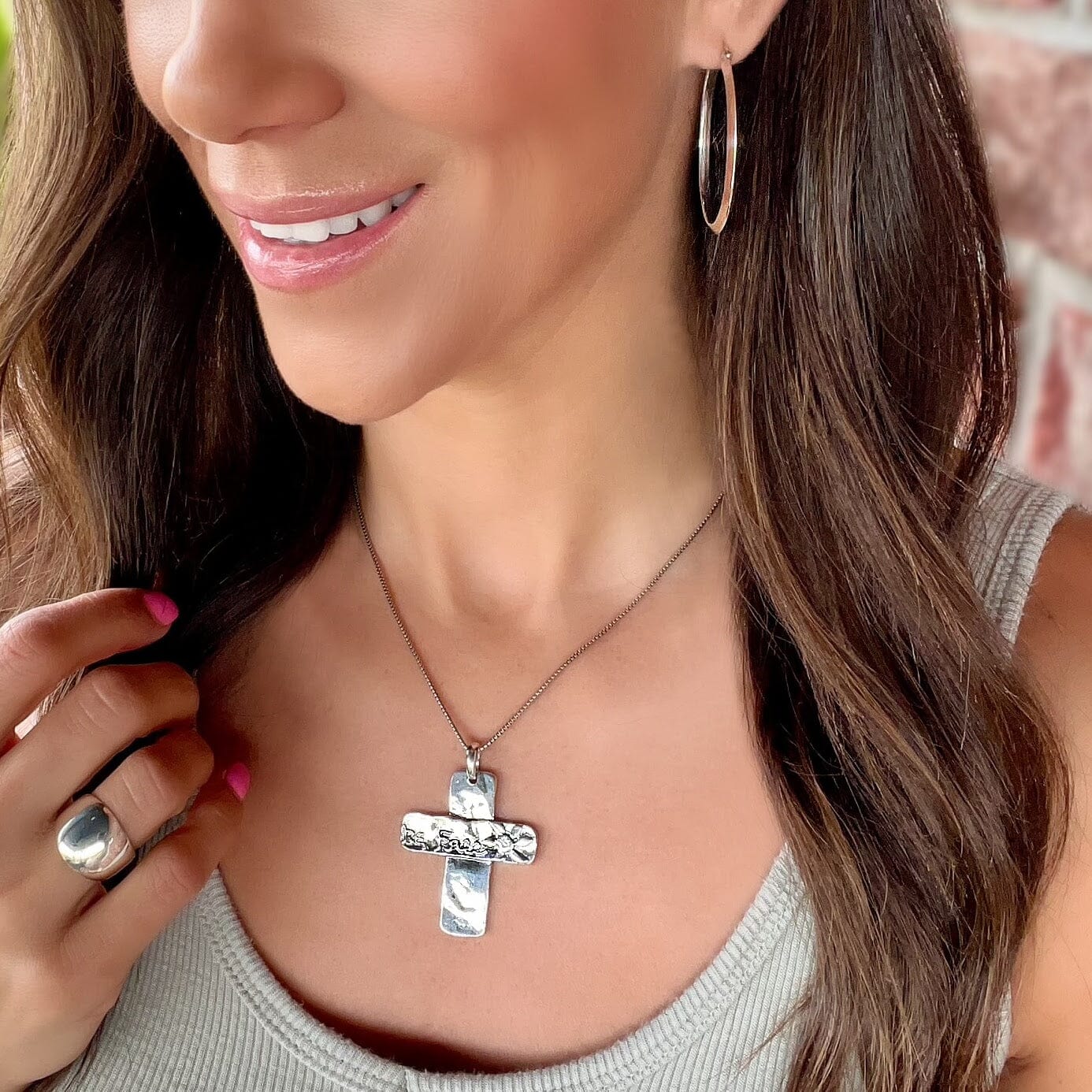 Chunky cross Be Free Necklace paired with oval hoop earrings and Classic Dome ring