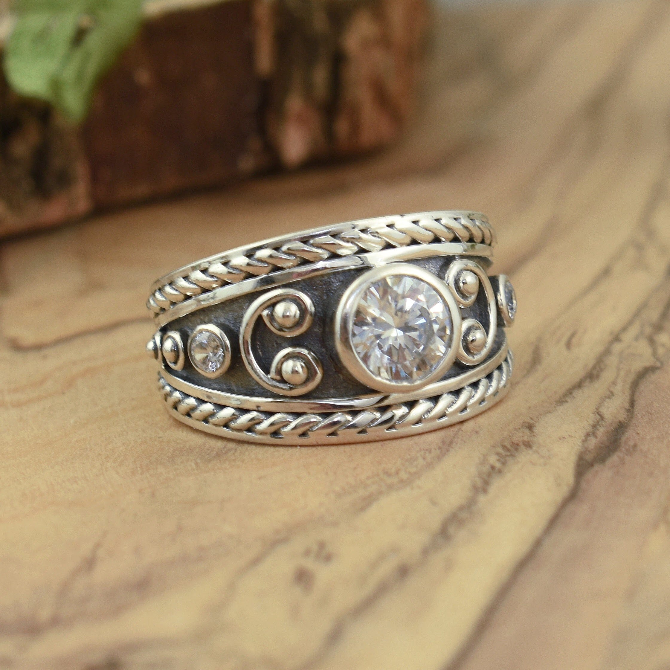 Designer inspired sterling silver ring with round cz accent stones