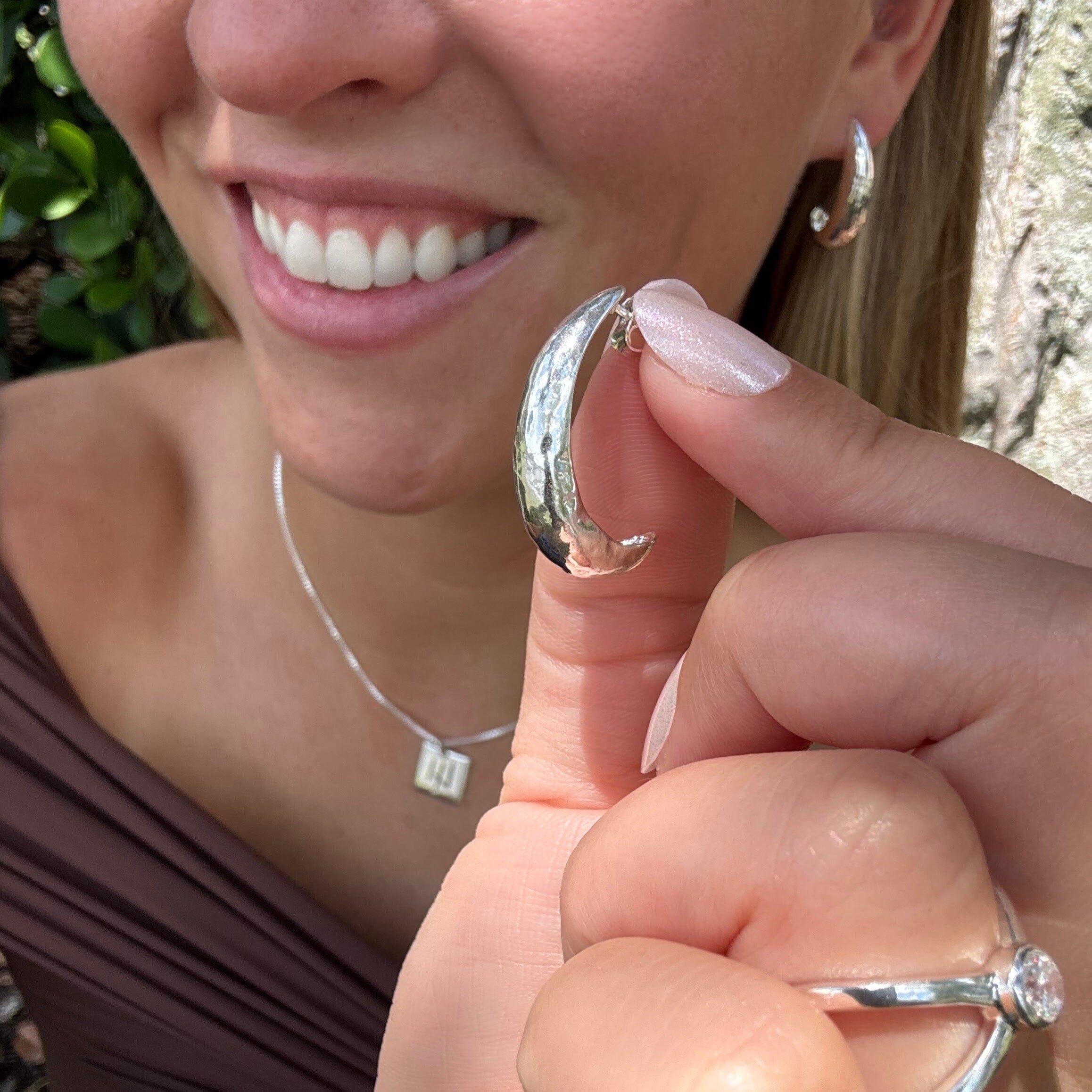 curved silver post earrings with a hammered texture