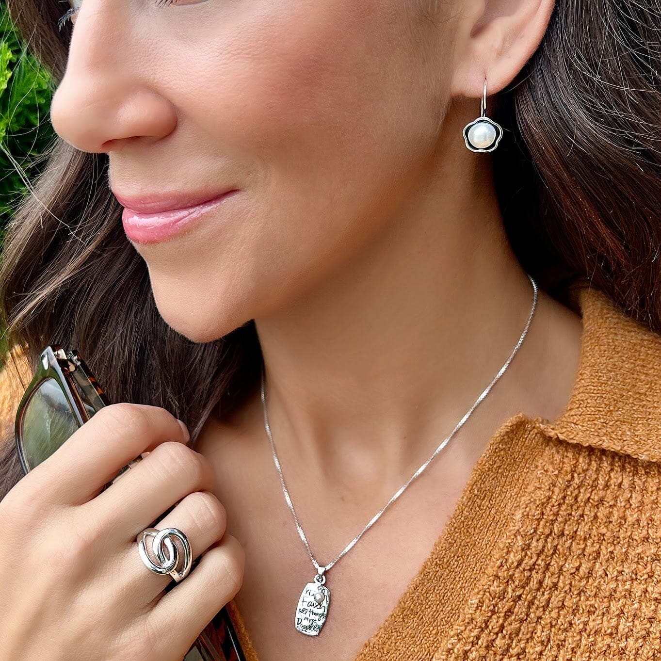 silver flower earrings with a pearl center