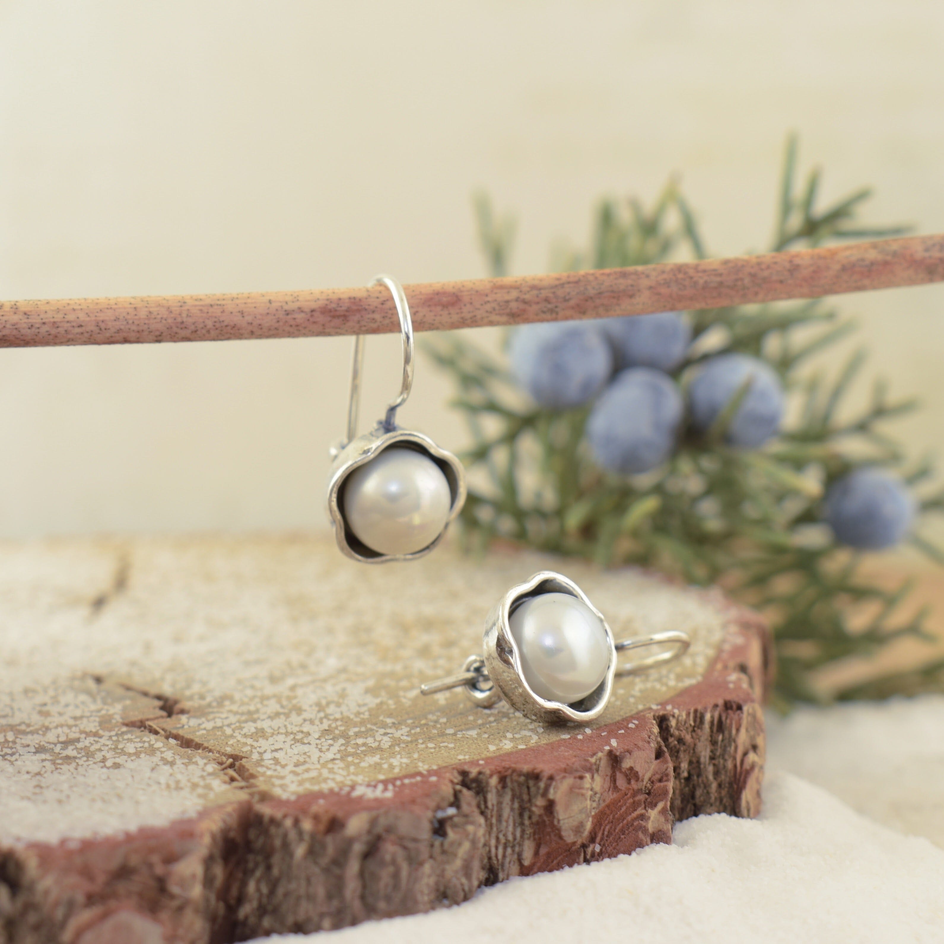 Sterling silver flower earring with a freshwater pearl in the center