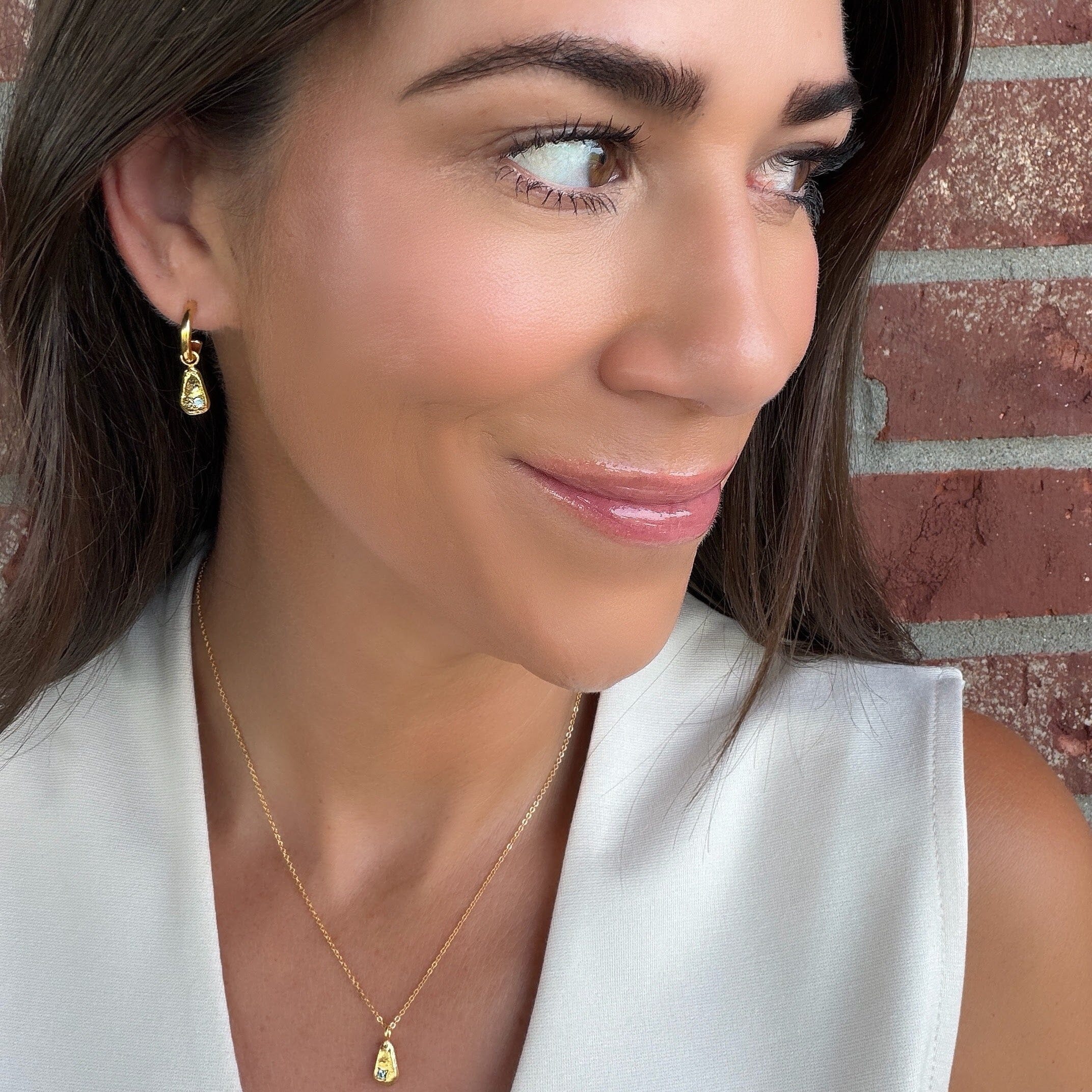 minimalist gold brass earrings featuring a tiny cz