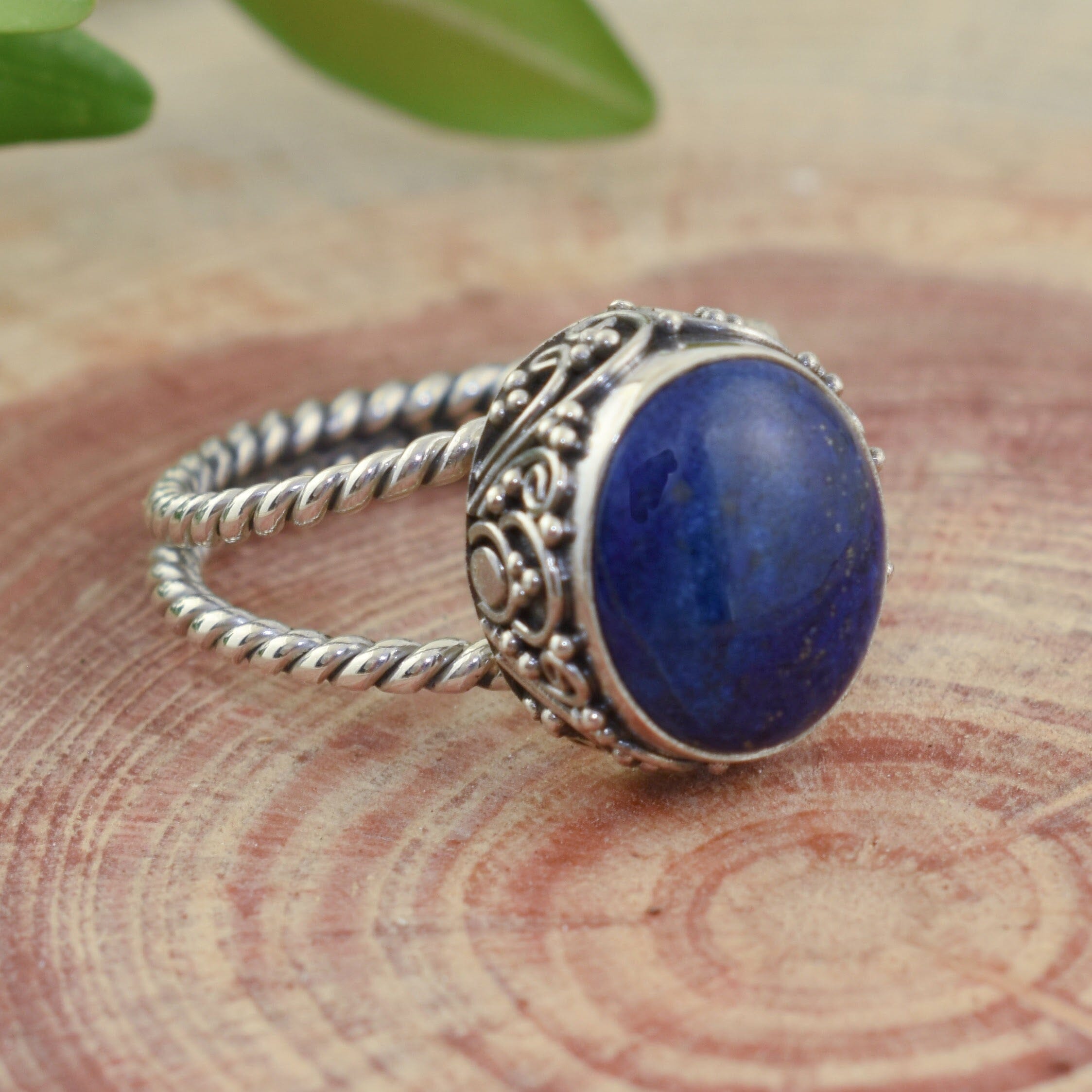 Oval-shaped blue lapis ring with ornate sterling silver band