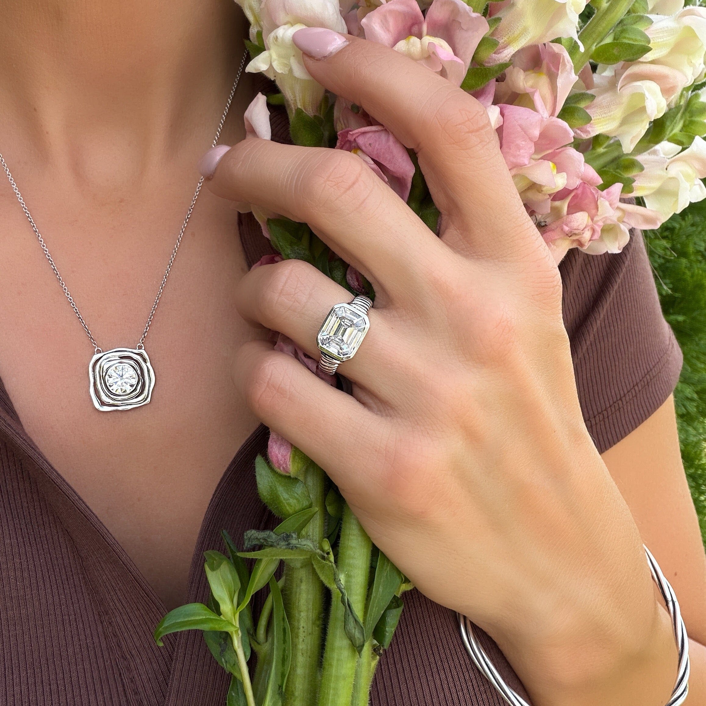 sterling silver ring with a ridged band featuring an emerald cut cz center stone