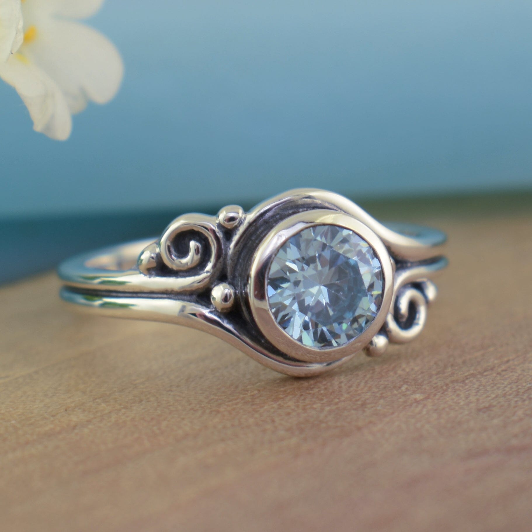 .925 sterling silver ring with swirled band and light blue cubic zirconia stone