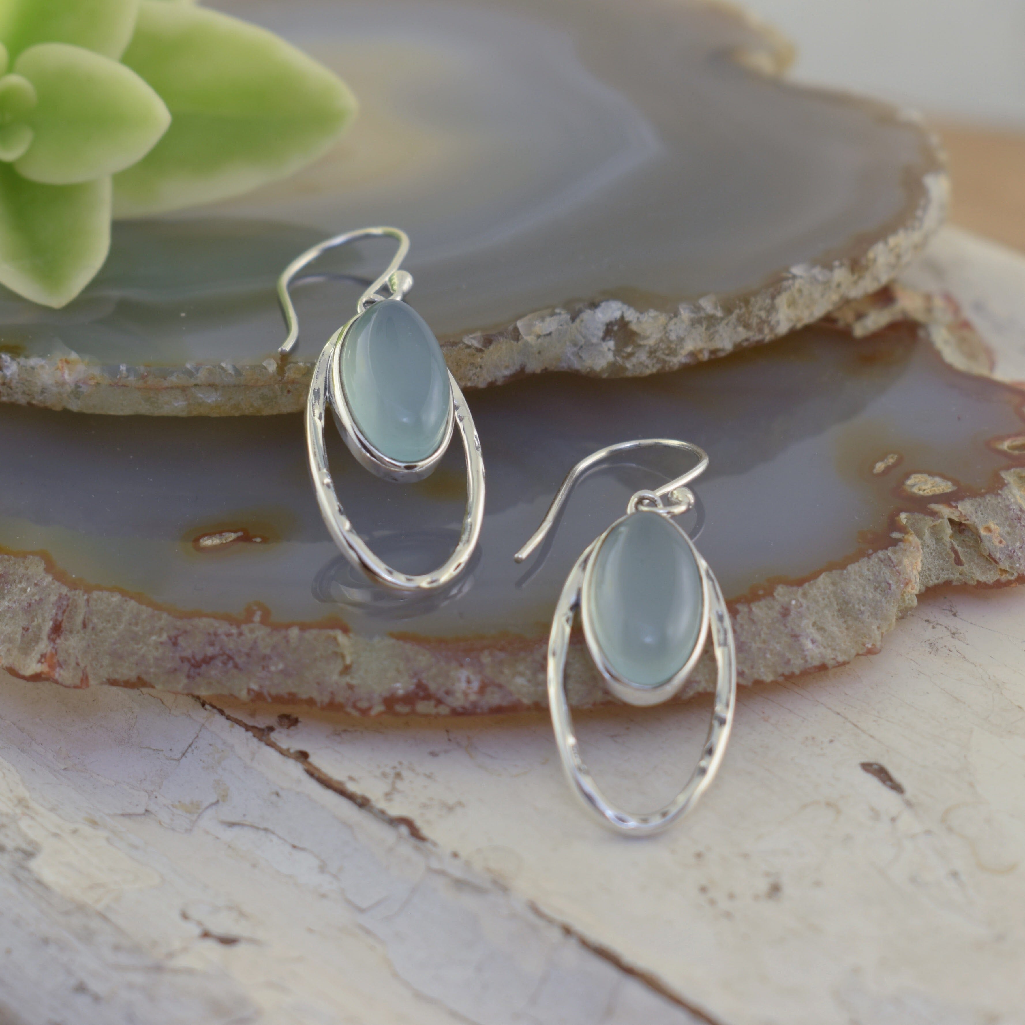 Handcrafted elongated oval shaped earrings featuring aqua-green chalcedony