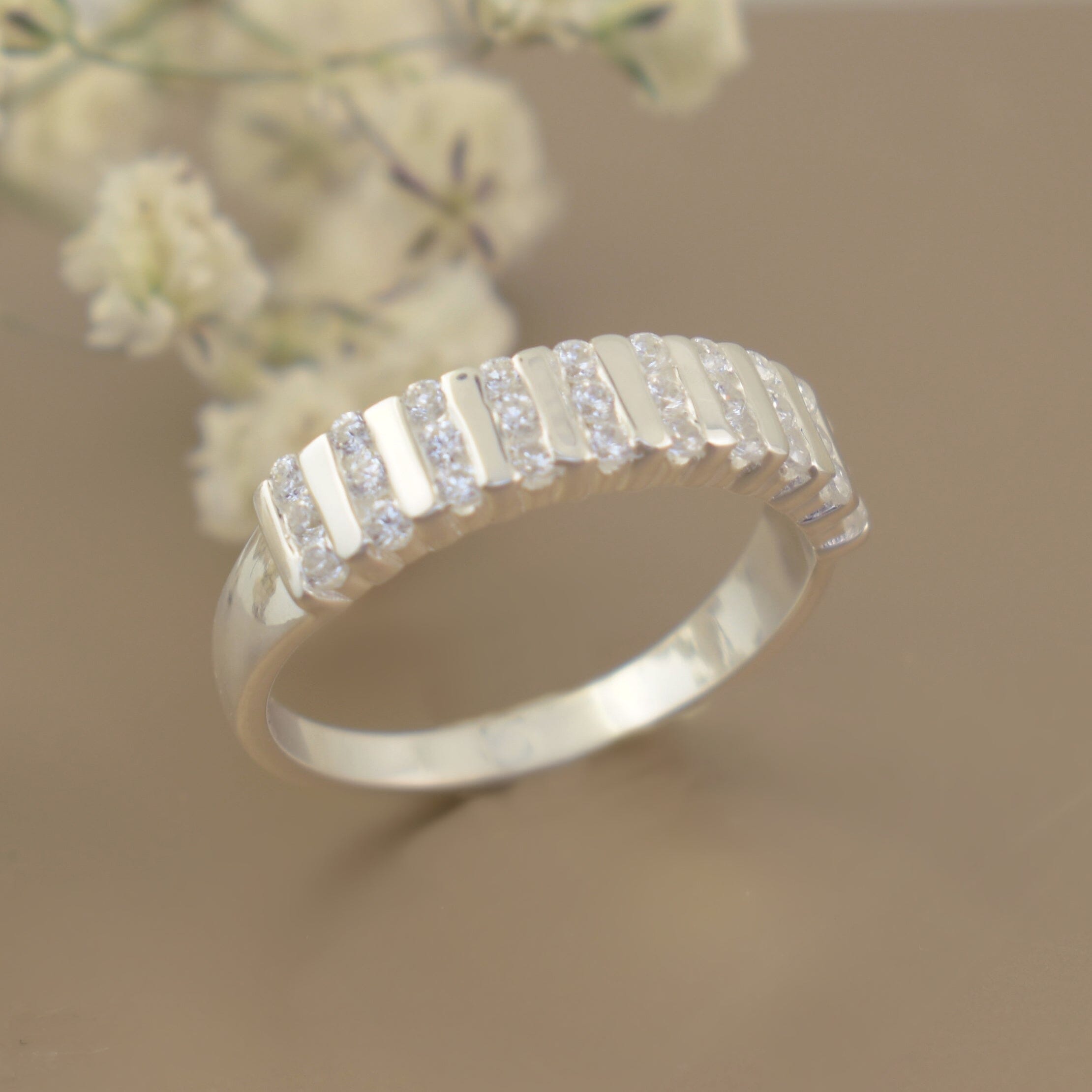 sterling silver wedding style band featuring 10 channels set with tiny cz stones