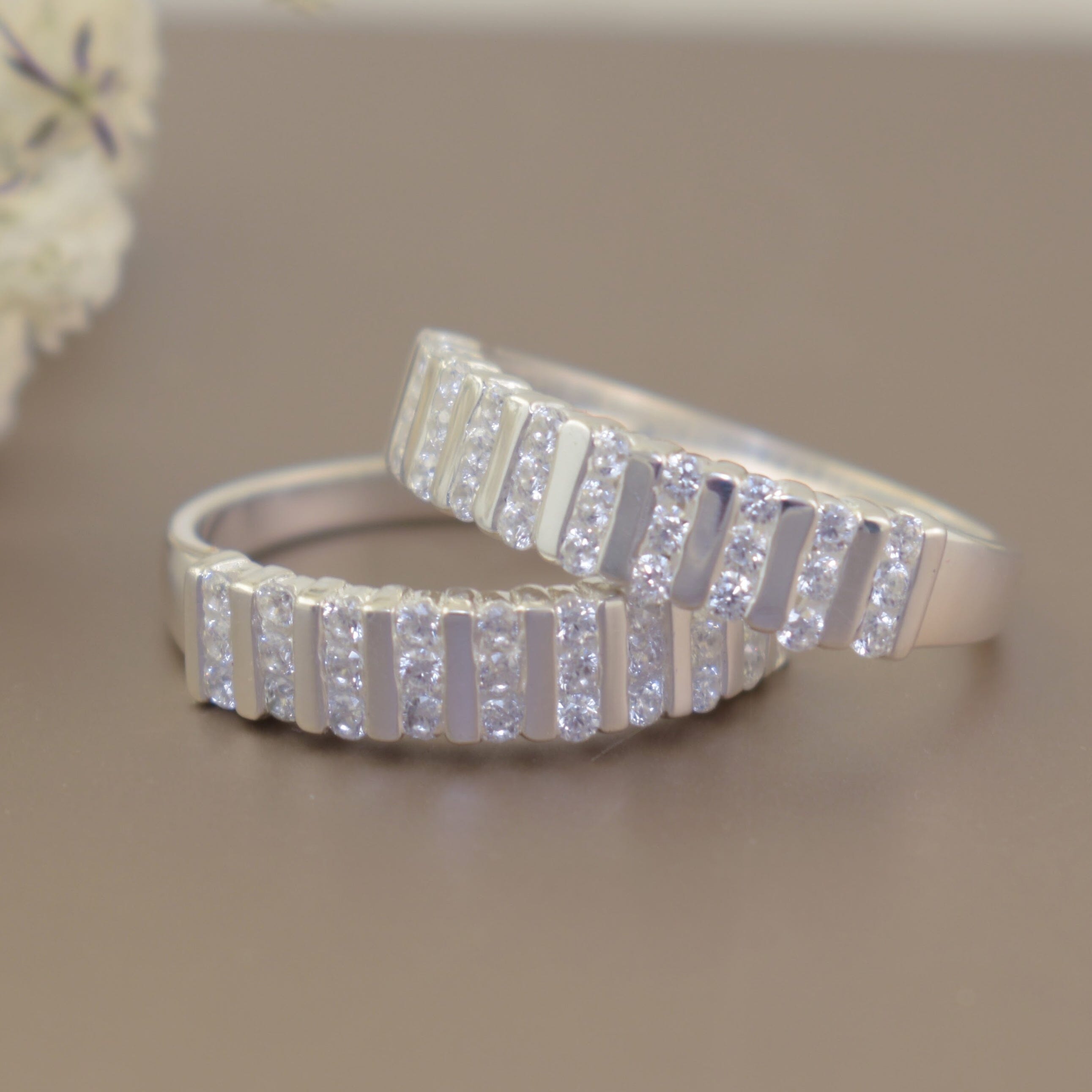 stackable sterling silver wedding style bands with several channels of cz stones