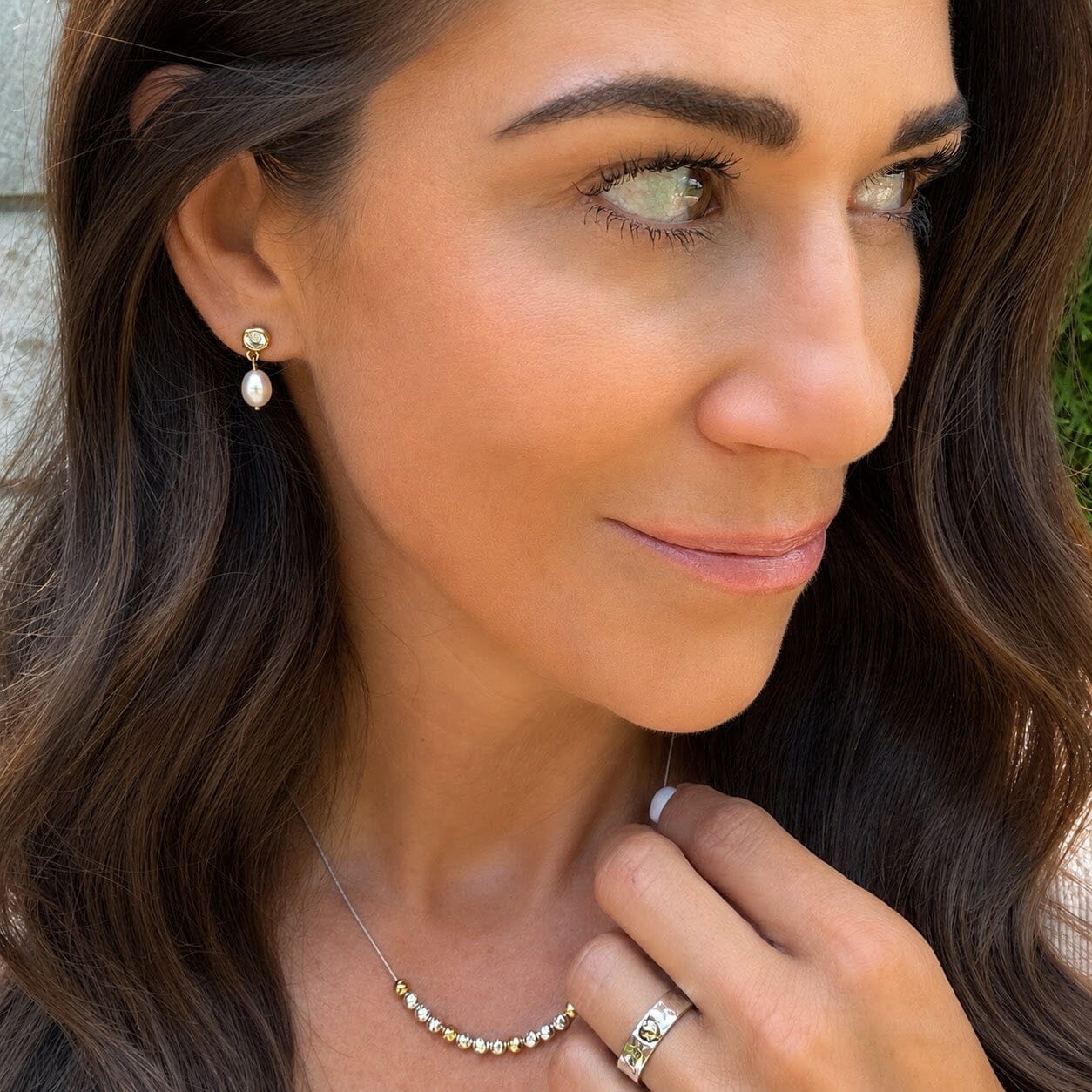 delicate gold earrings featuring a pearl dangle