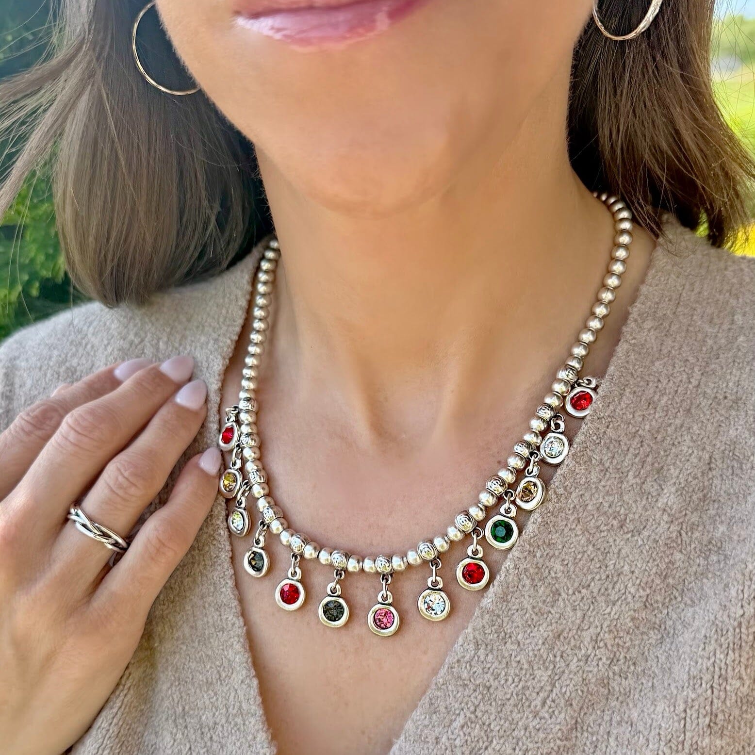 silver necklace with various colored crystals