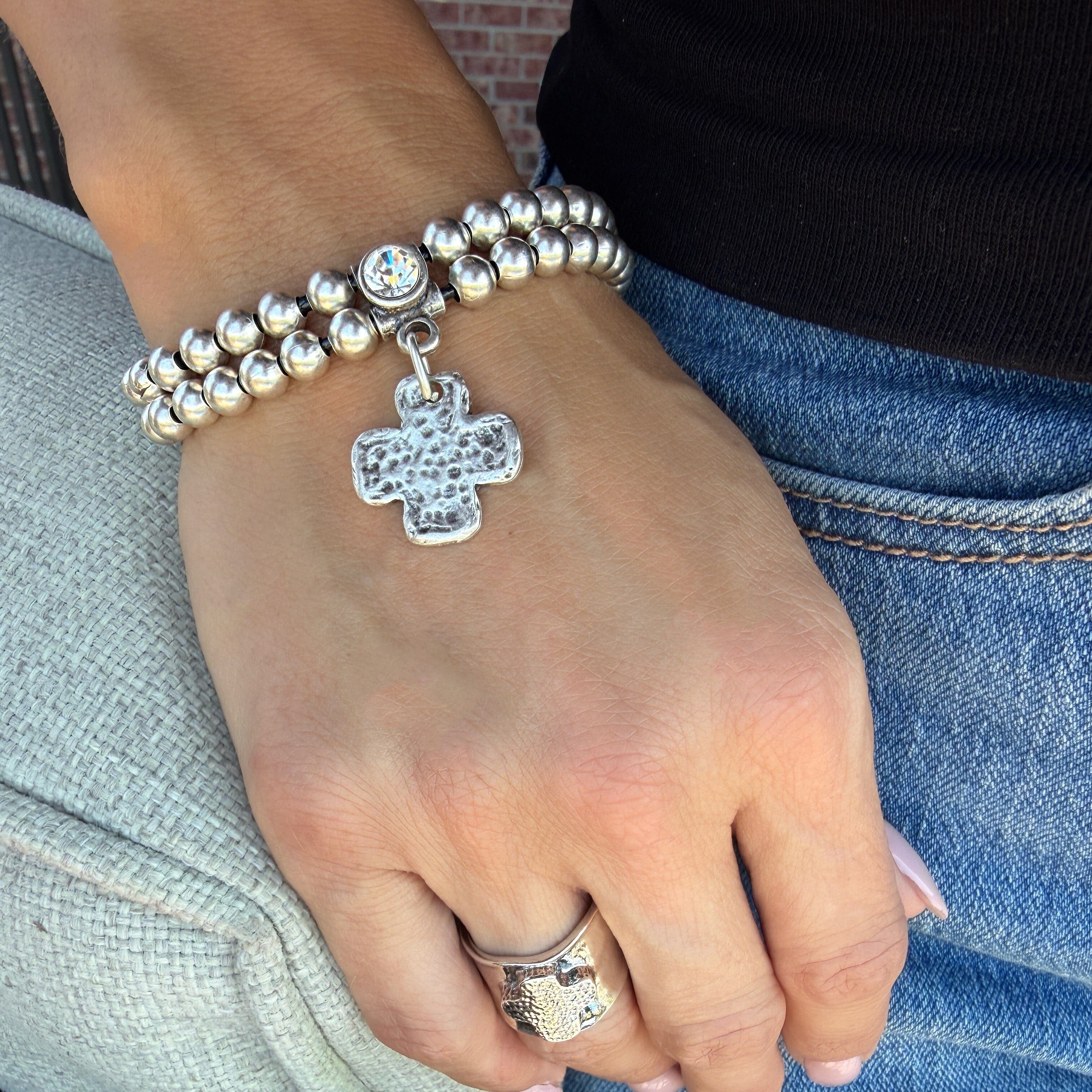silver plated beaded bracelet featuring a cz and hammered cross dangle