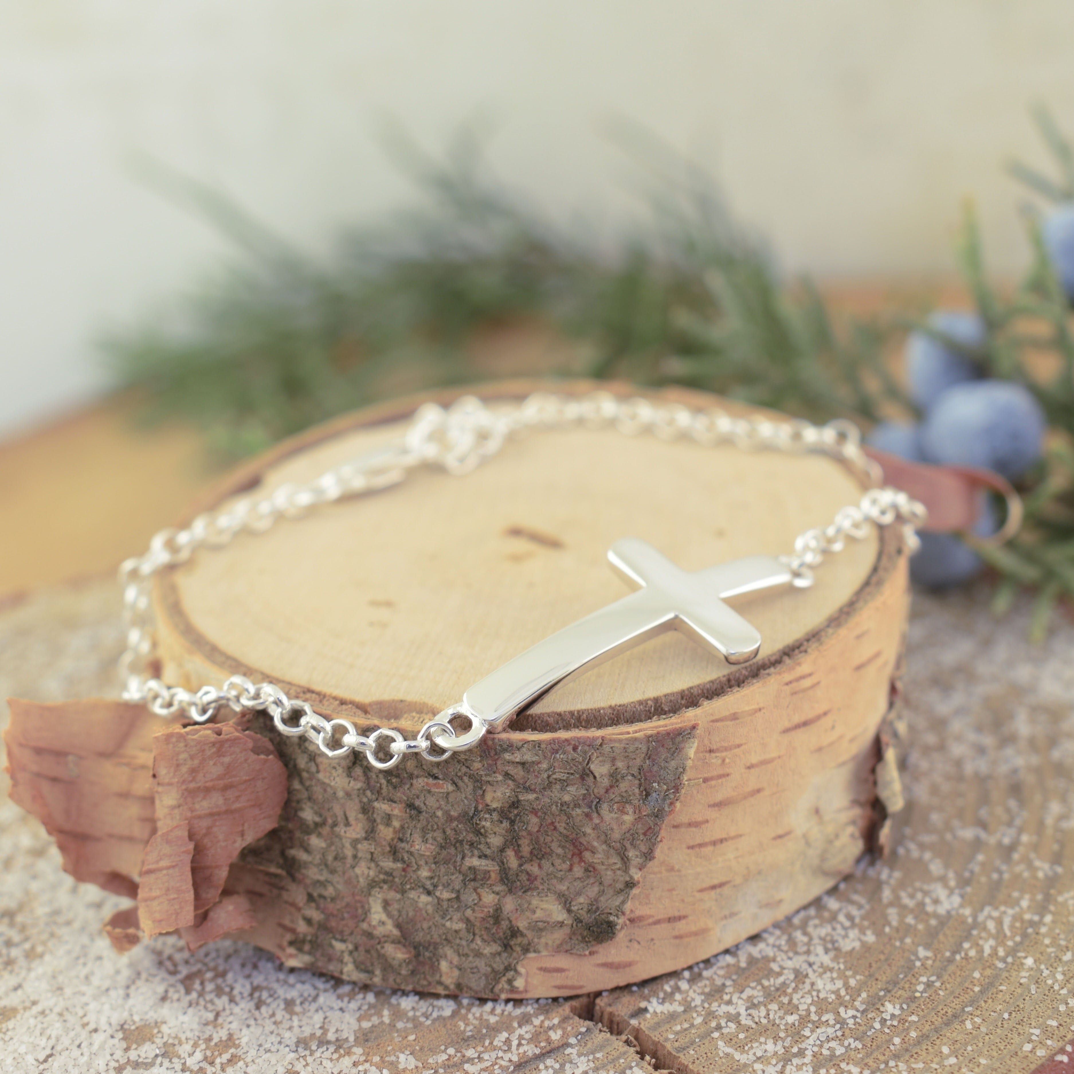 Sterling silver link bracelet with a cross in the center