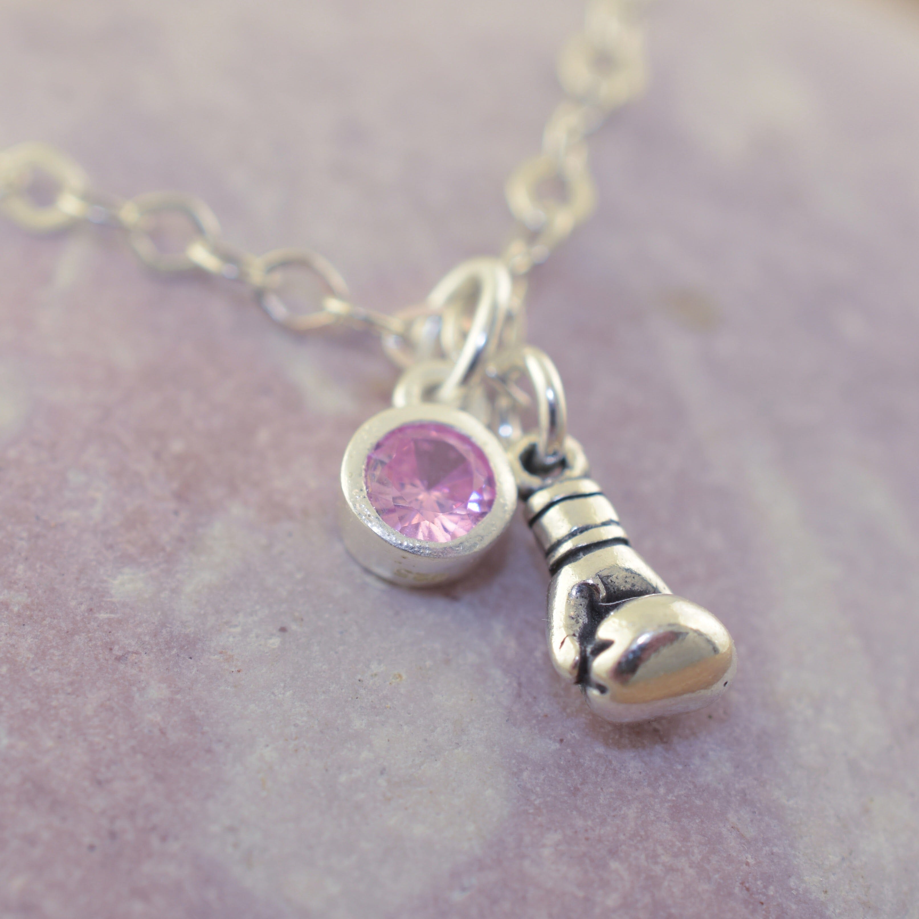 Boxing glove and pink cz dangle on ladies bracelet.