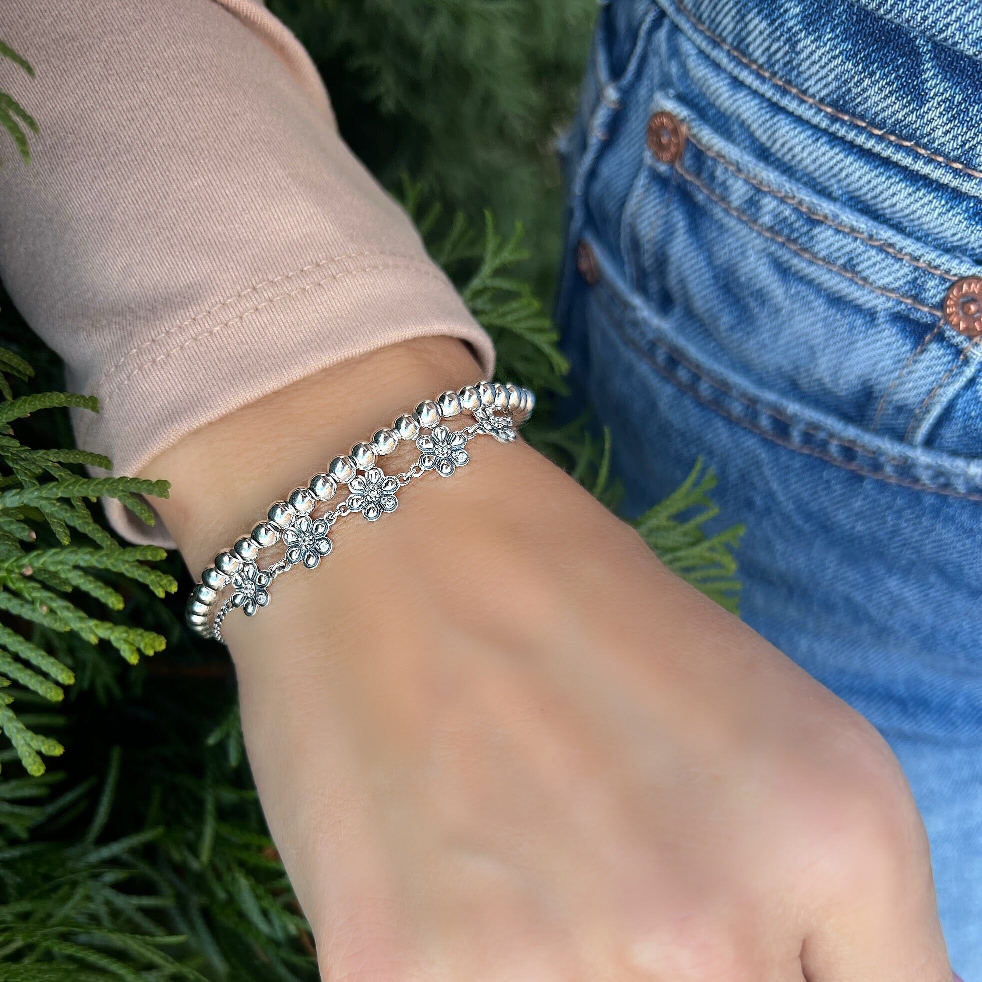 Daisy bracelet with CZ stones in the center of the flowers. paired with the faith bracelet