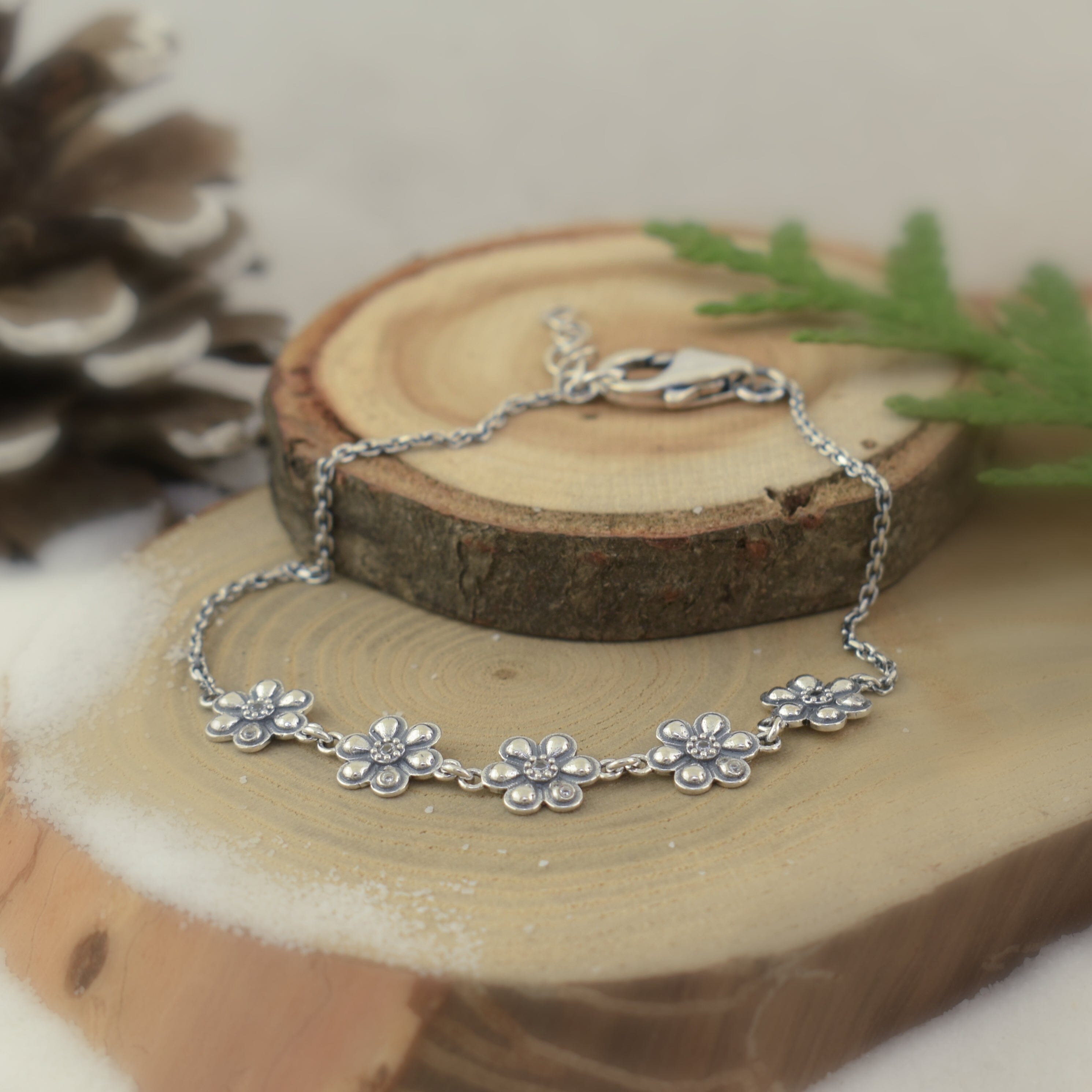 .925 sterling silver daisy-inspired bracelet featuring cubic zirconia stones