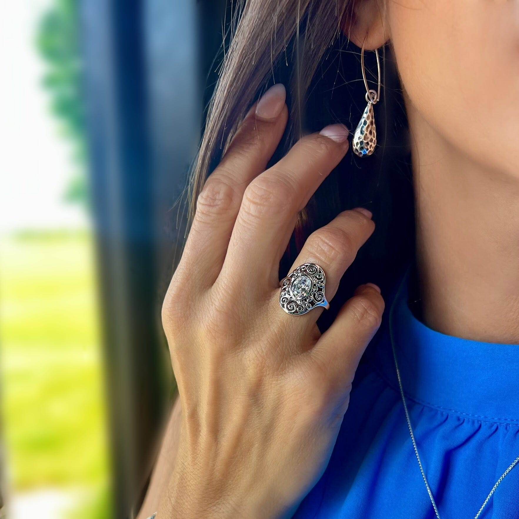 Bezel set sterling silver ring with swirls paired with mucho Gusto  earrrings