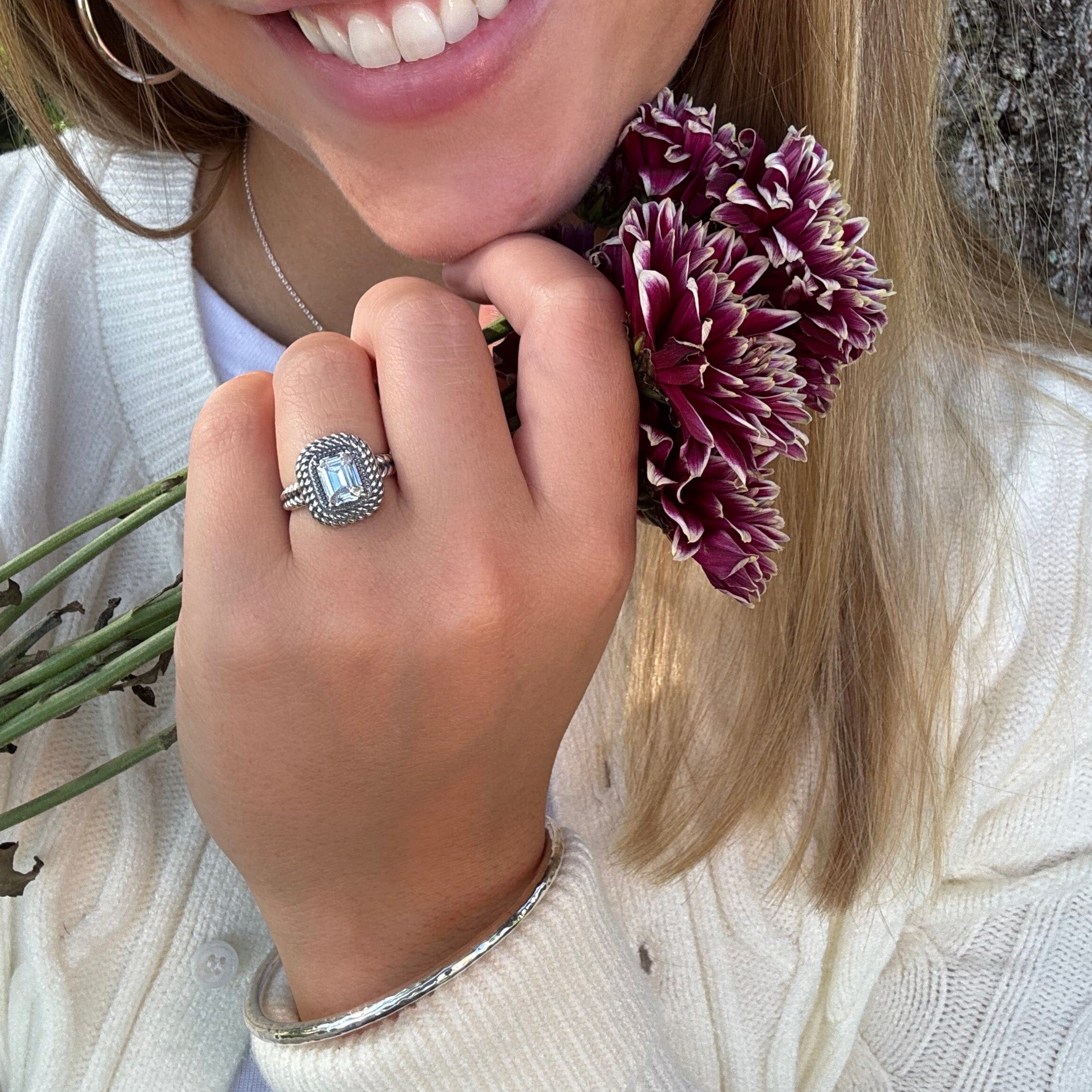 designer silver ring featuring prong-set emerald cut cz