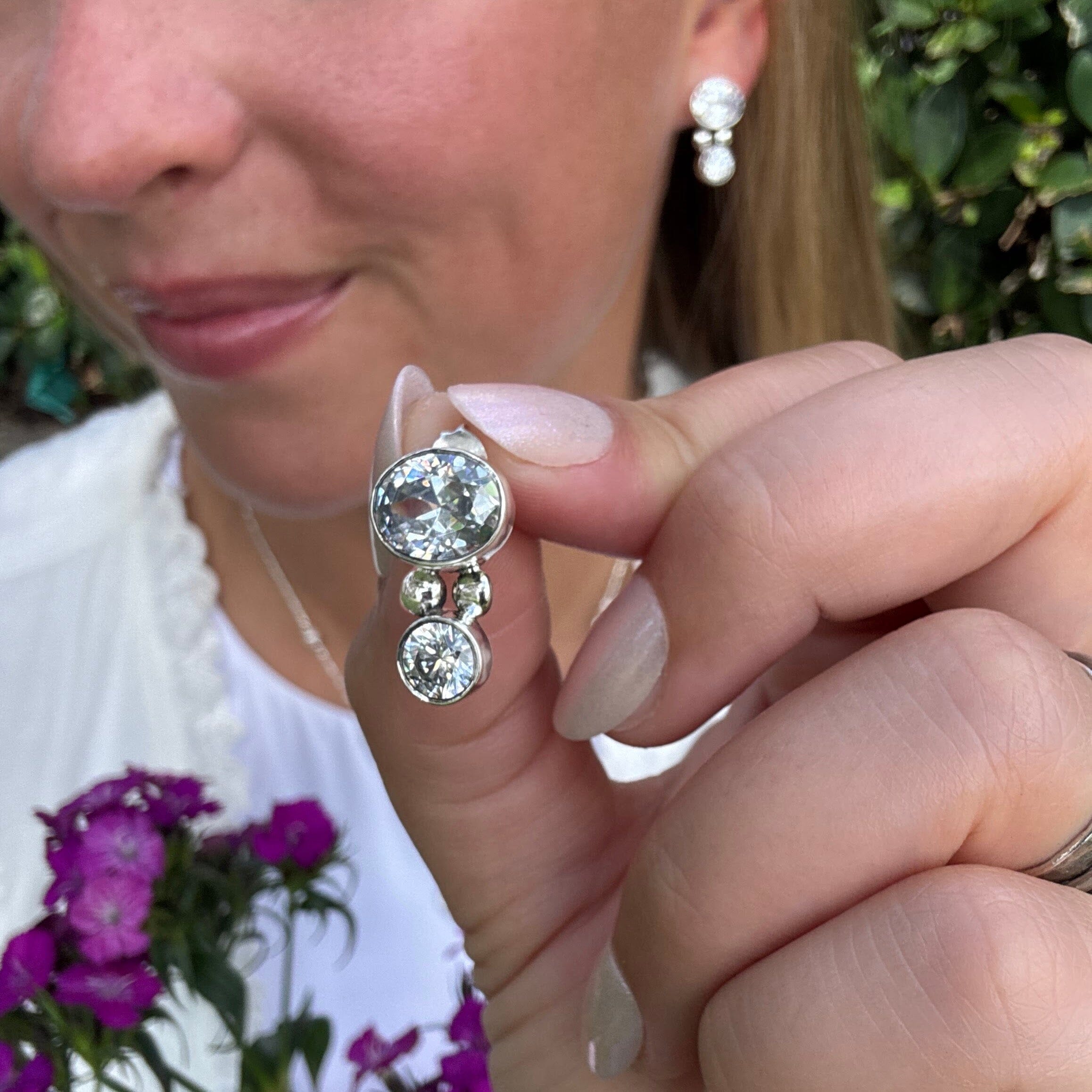 push-back post earrings in sterling silver featuring two bezel-set cubic zirconia stones