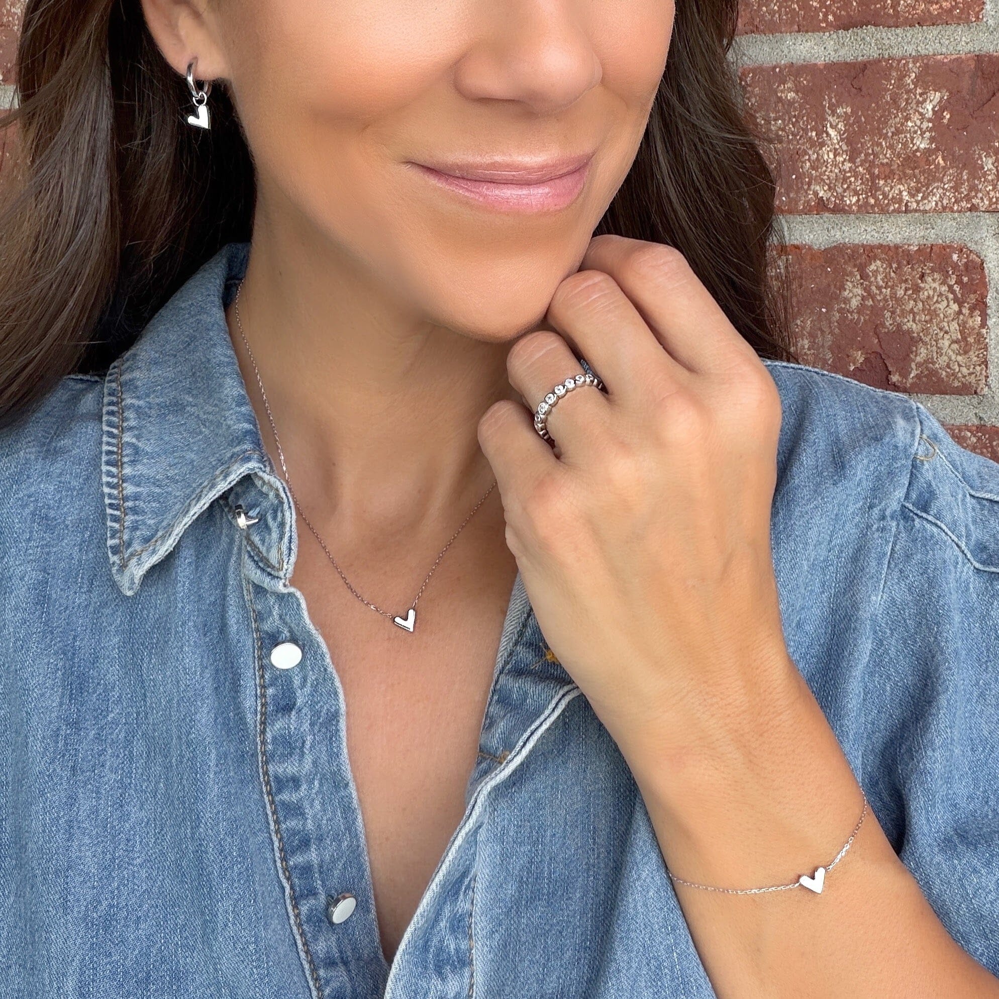 matching Double Take bracelet and necklace featuring a white enamel heart pendant