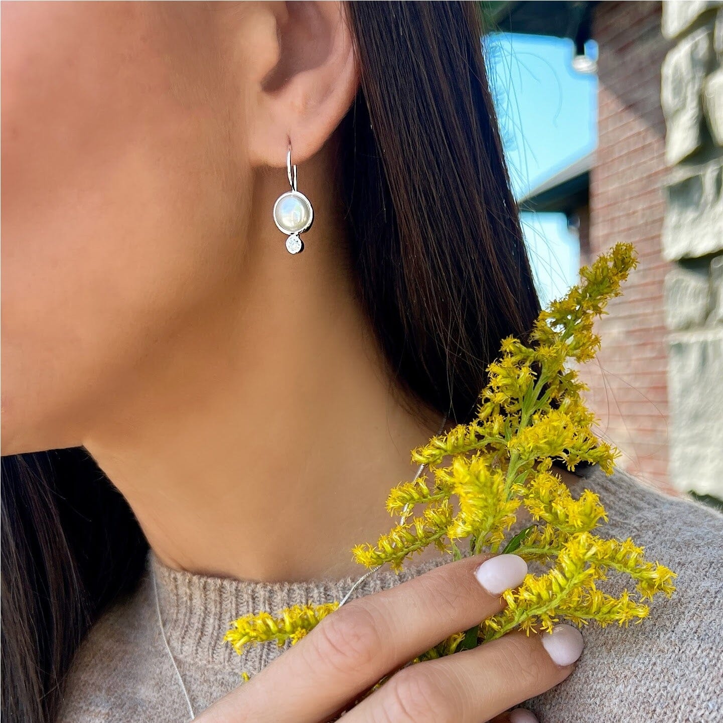 sterling silver dangling earrings featuring a freshwater pearl and cz drop