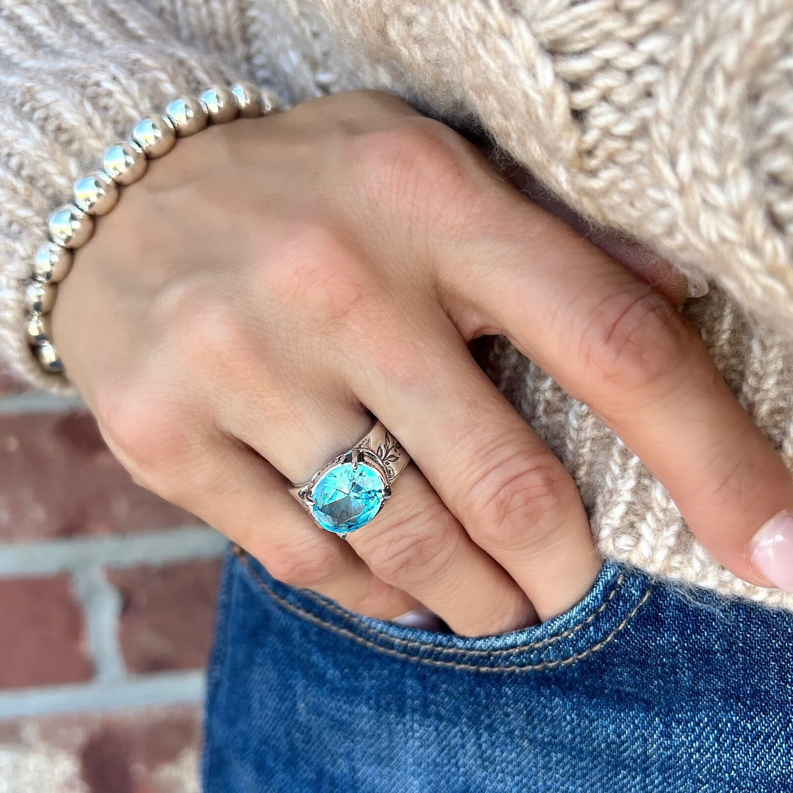 sky blue cz ring with engraved words and vines