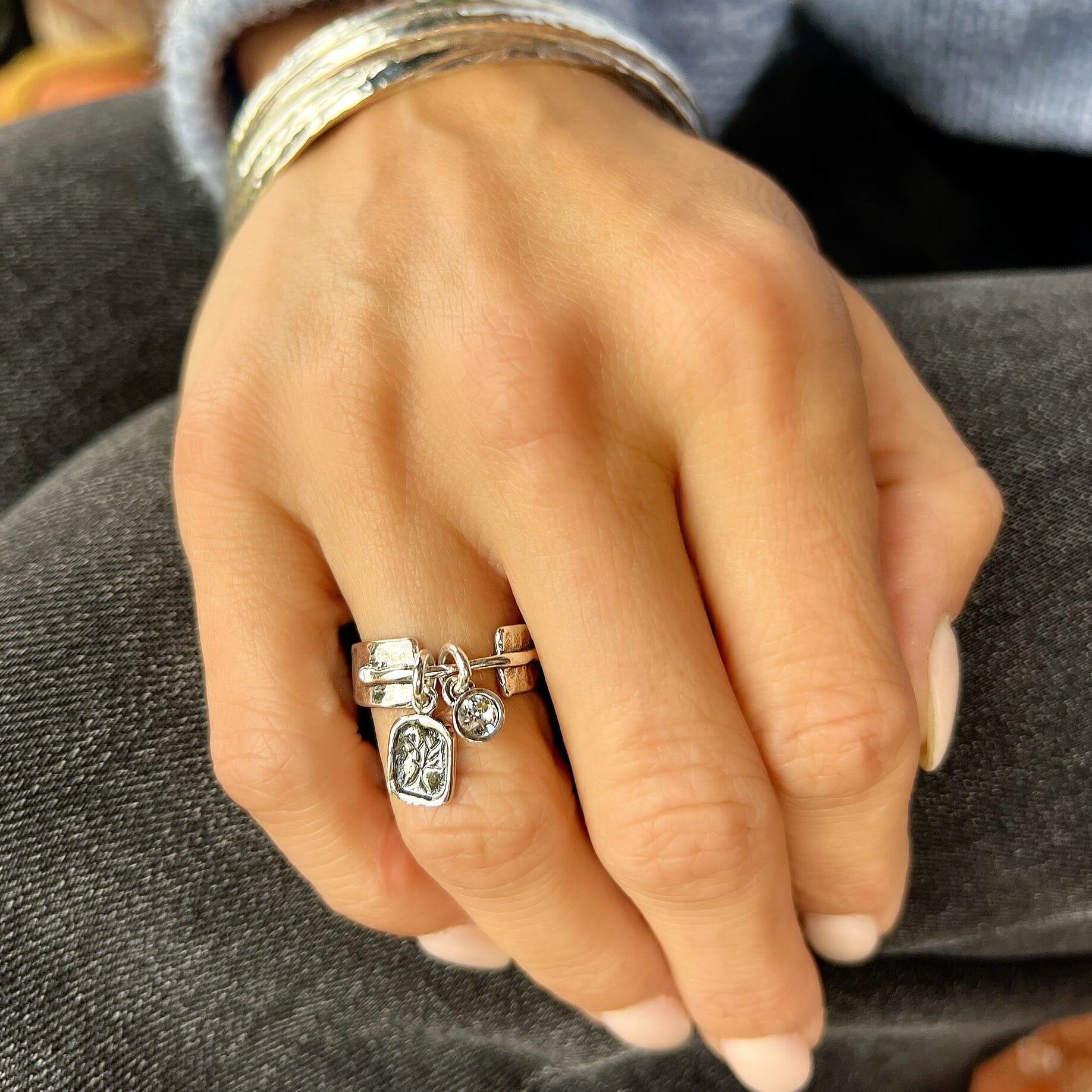 medium width silver band with a stamped tree dangle and bezel-set cz dangle