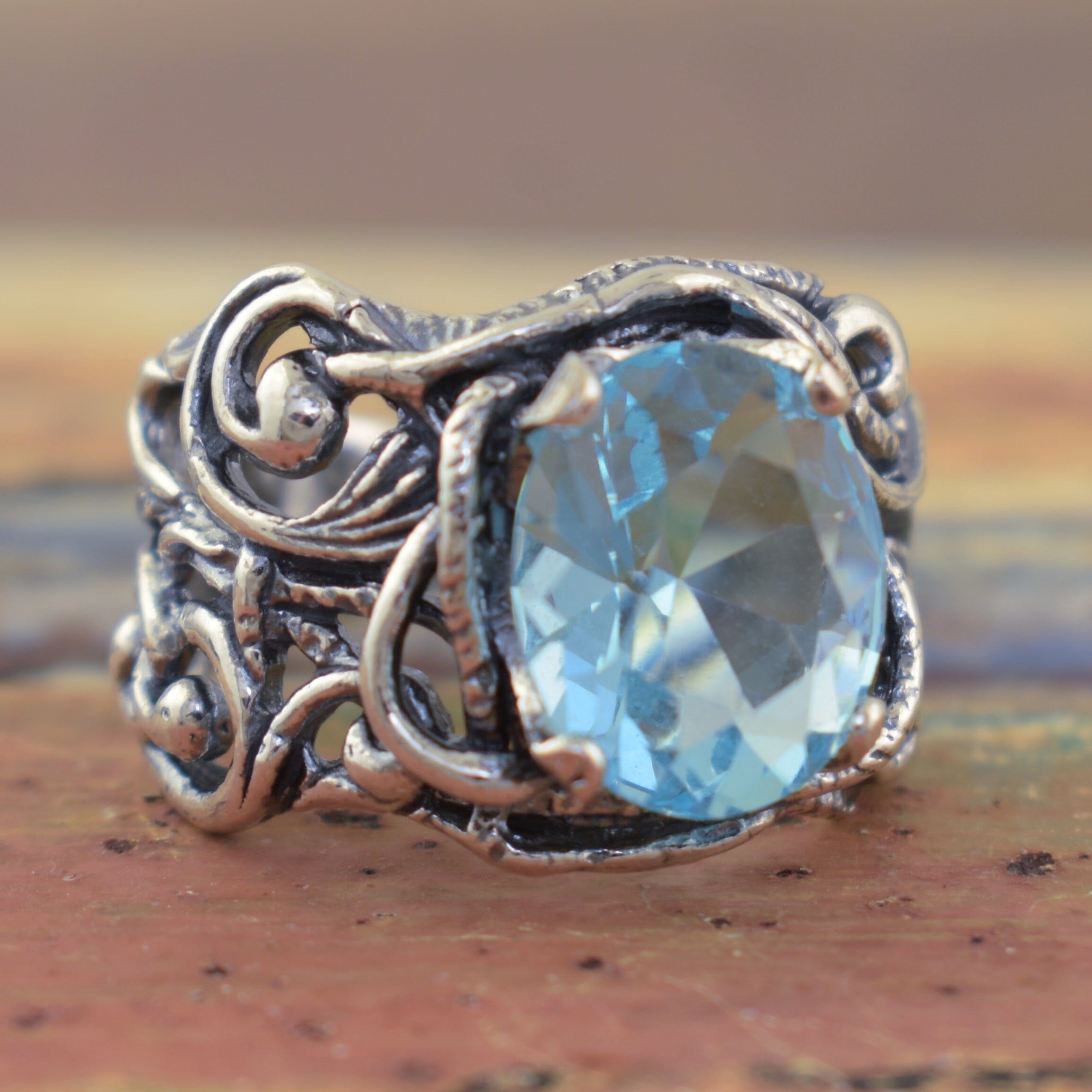 chunky sterling silver ring with a prong set blue stone