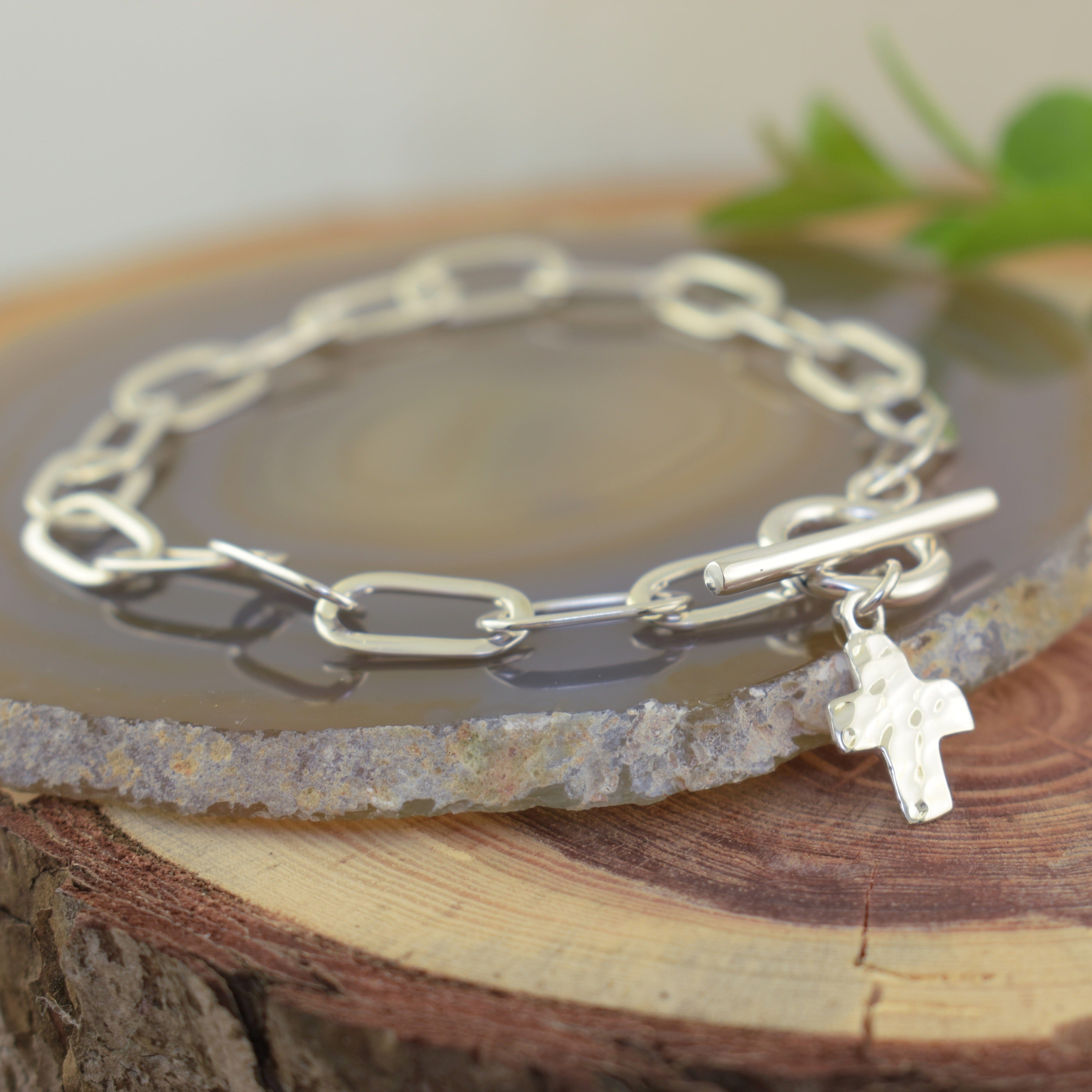 .925 Silver with high polished finish and a cross hanging off toggle closure