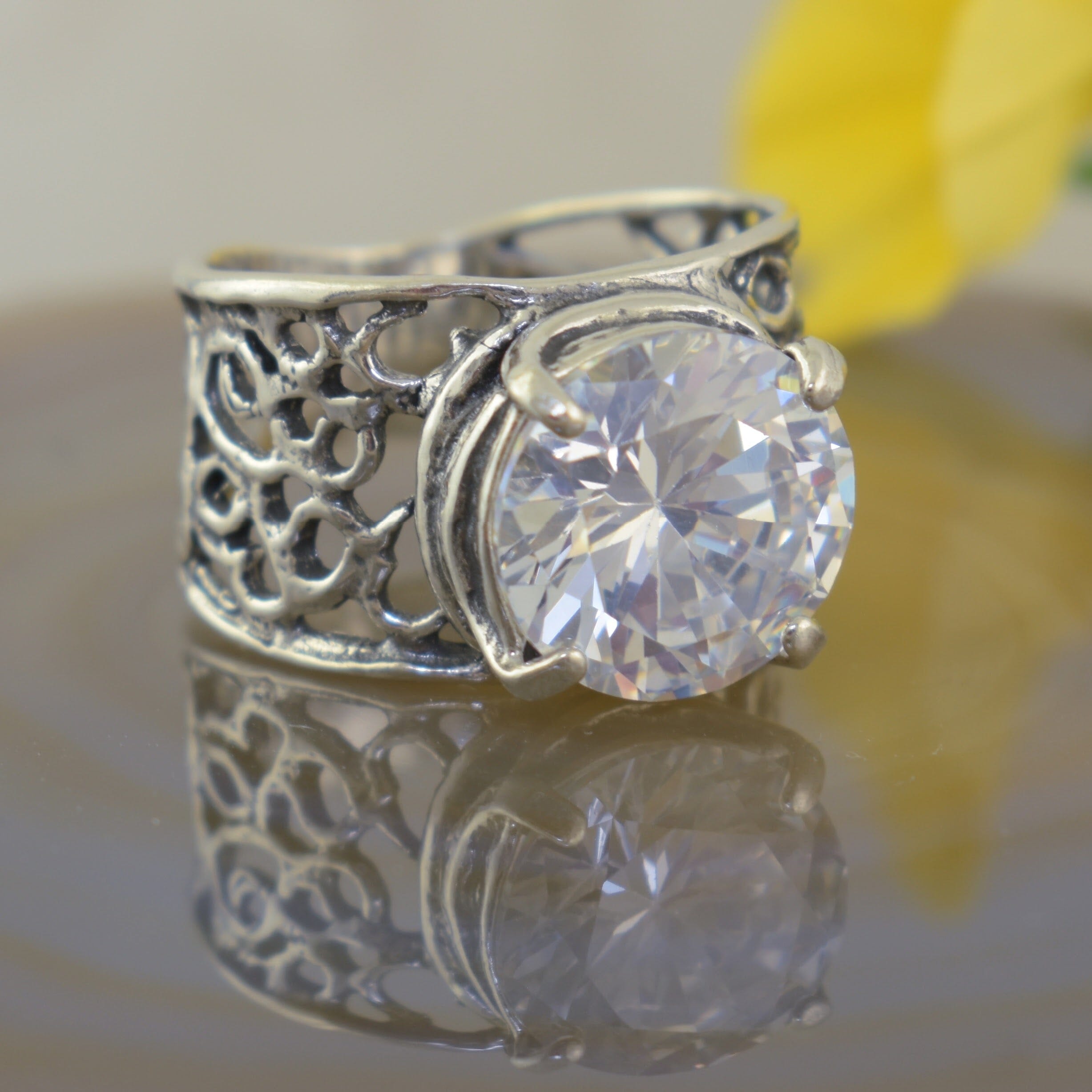 wide band sterling silver ring with a prong set Cz stone