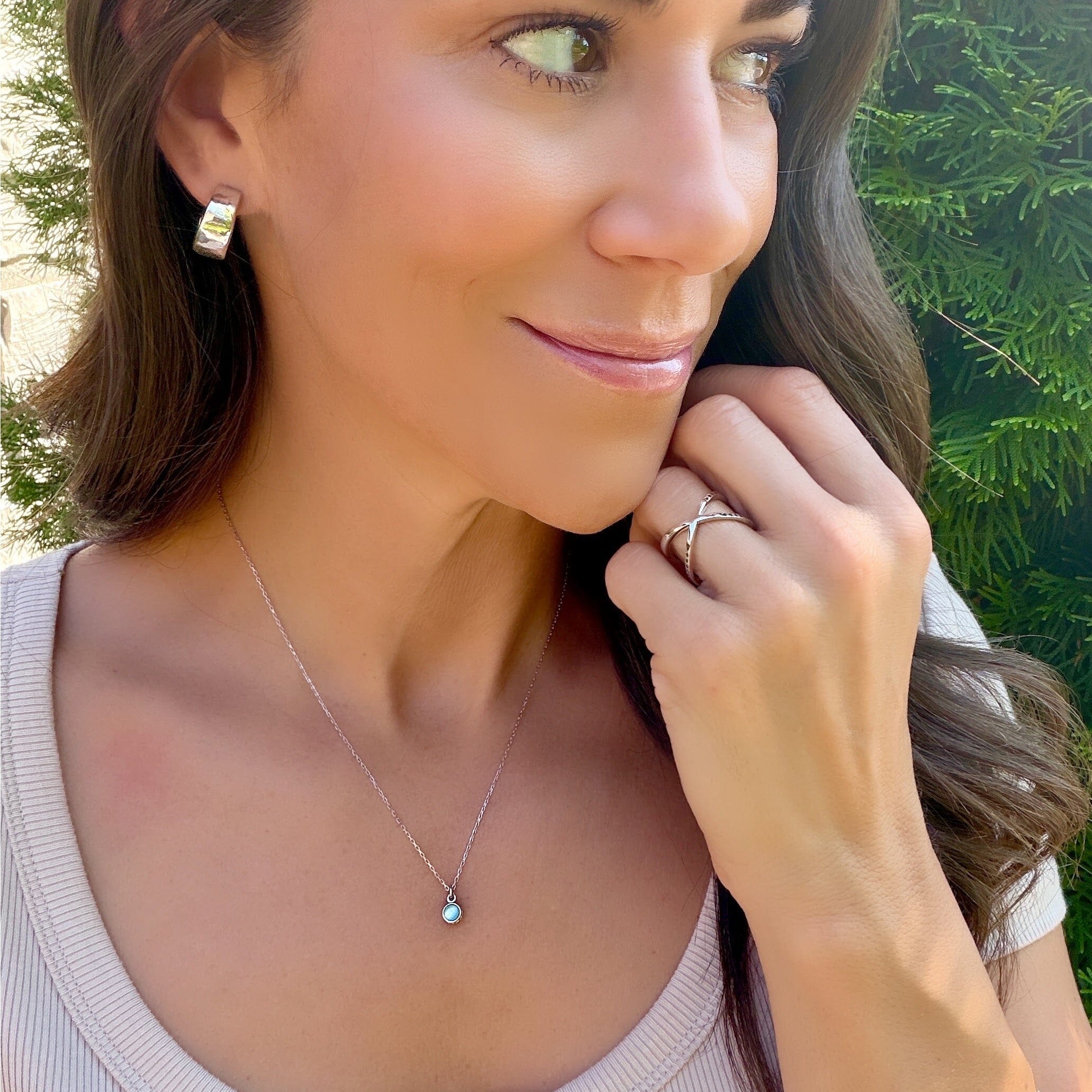 delicate sterling silver chain featuring a reversible blue and green zircon pendant