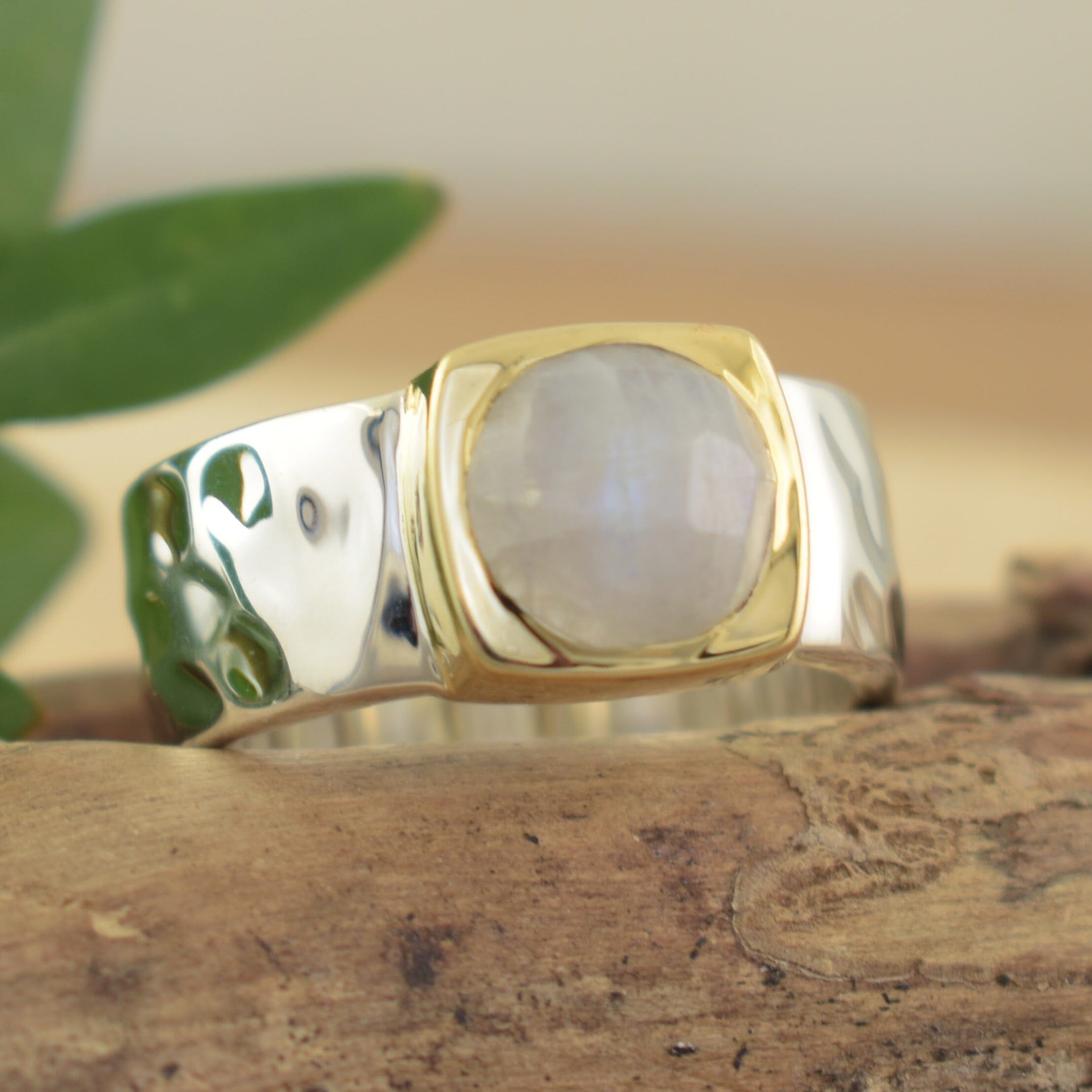Sterling silver hammered band ring with a bezel set stone