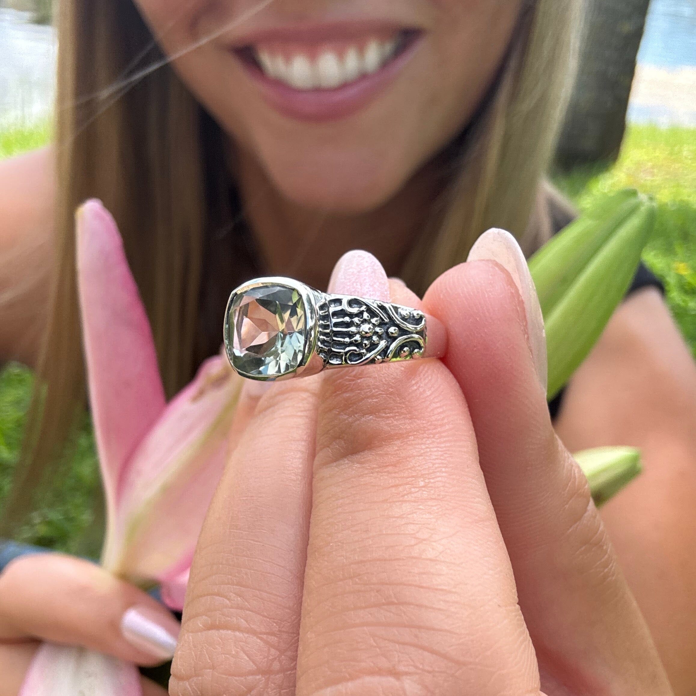 floral designer ring featuring a light green amethyst center stone