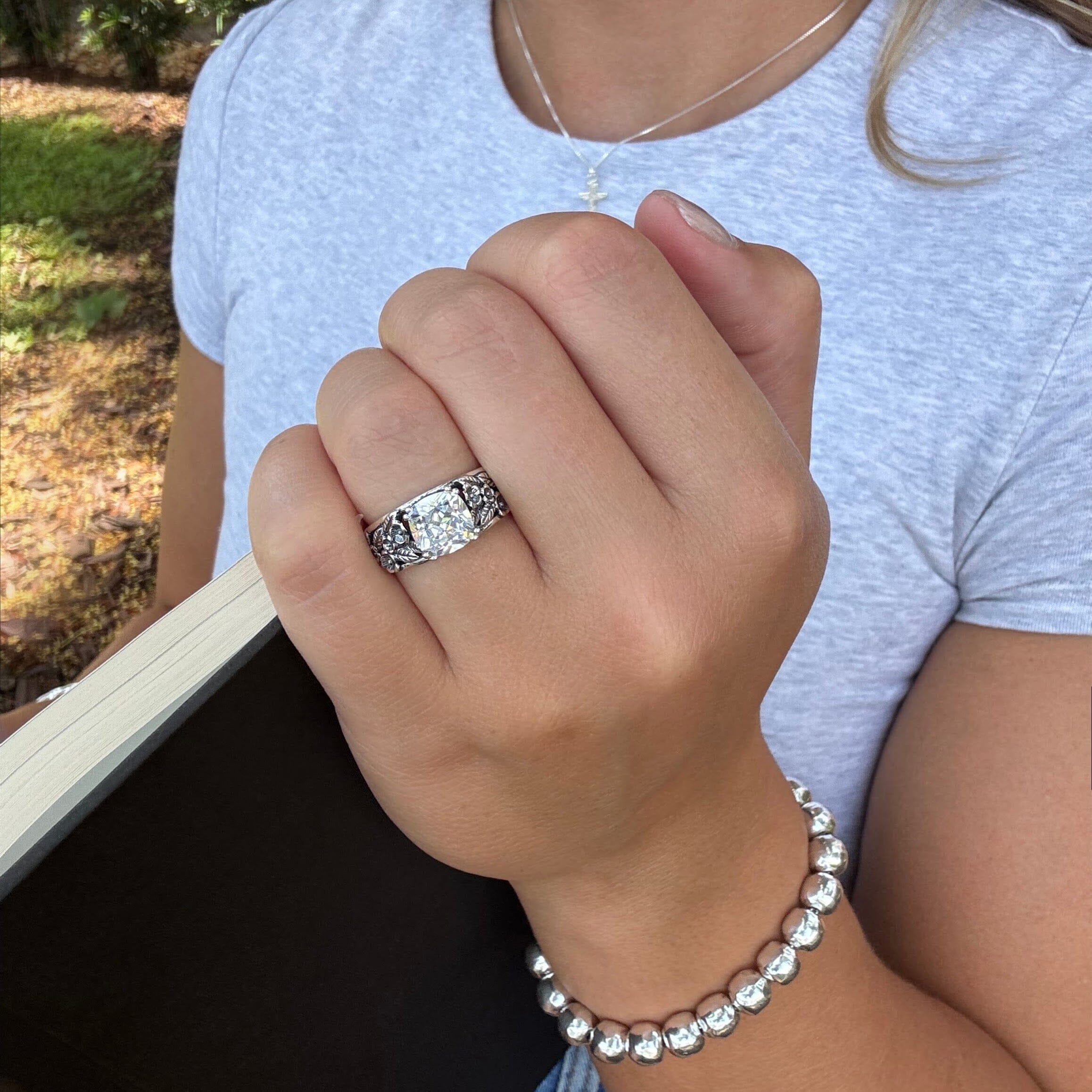medium width flower ring with a prong-set cubic zirconia center
