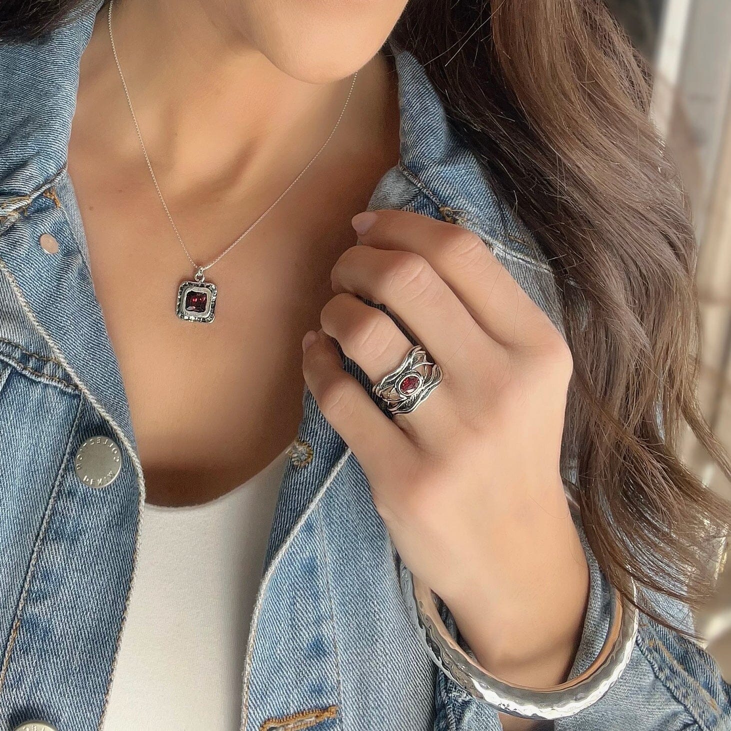 .925 ring with a oxidized curvy band and garnet cz stone. paired with the hammered bliss bangle and crimson caress necklace