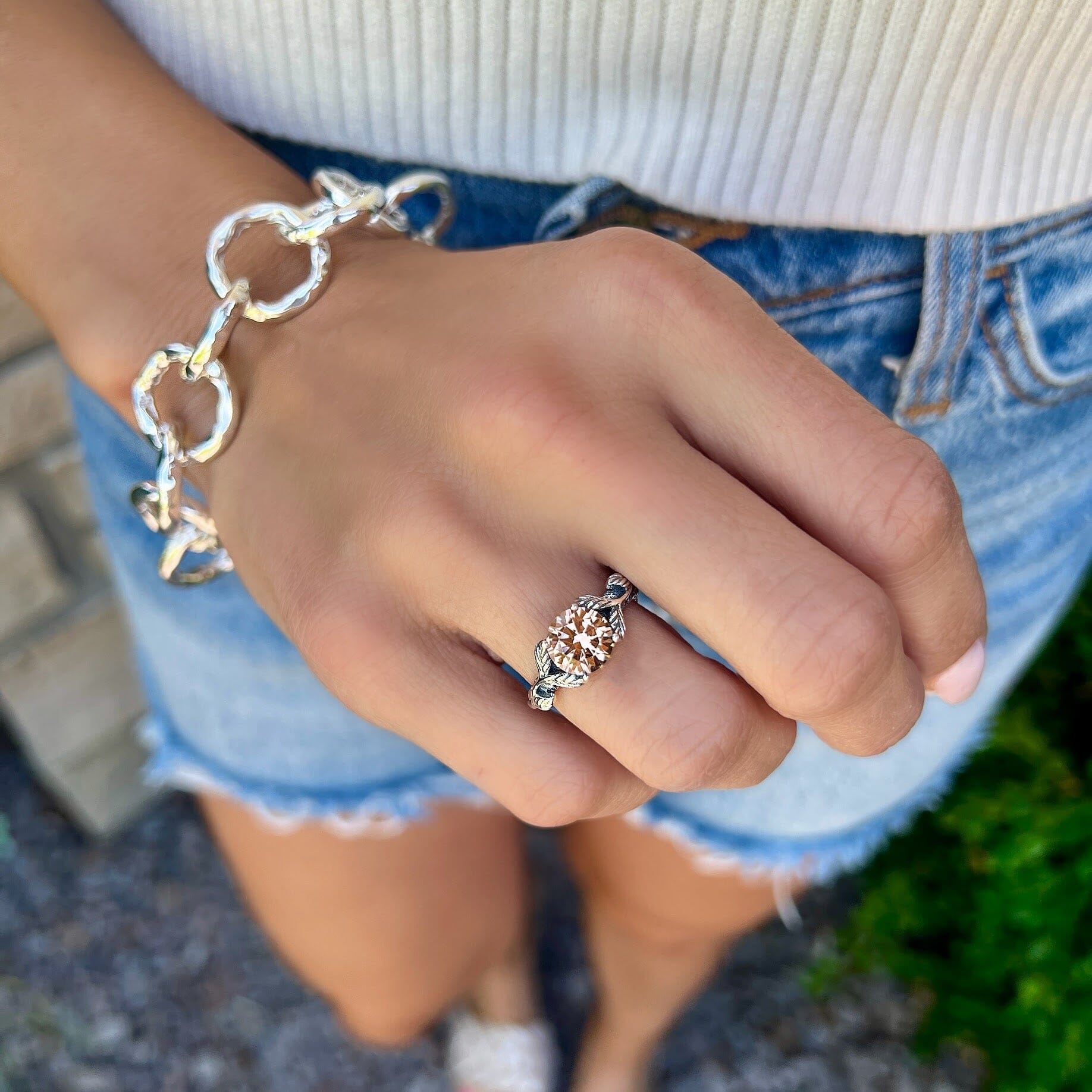 Sterling silver ring featuring a round CZ stone with leafy band