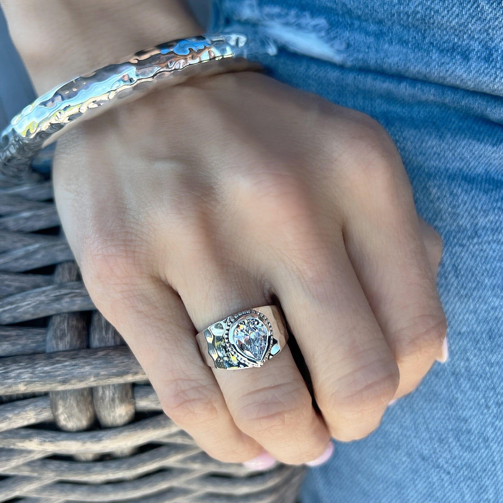 hammered pear-shaped cz ring with a beaded frame