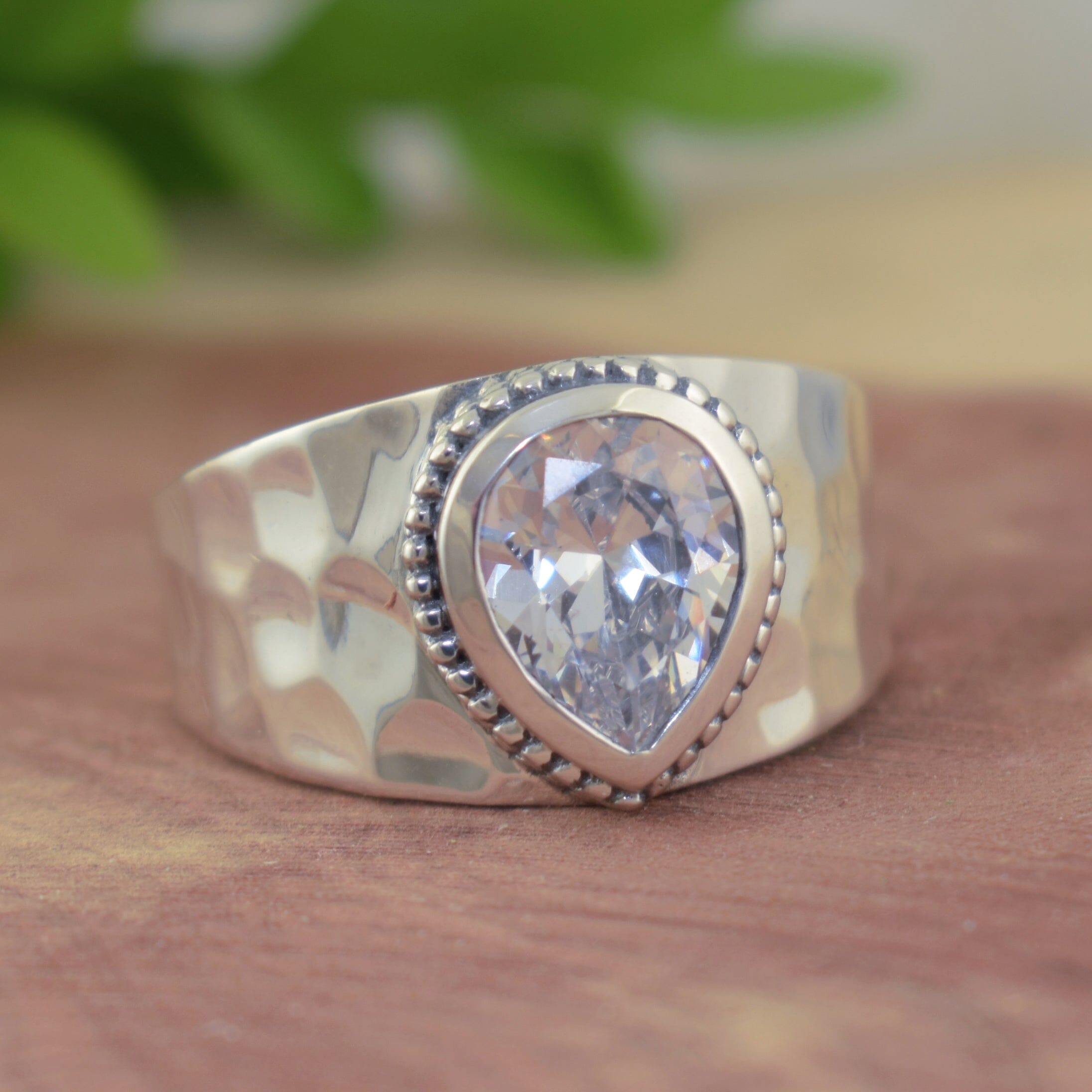 .925 sterling silver ring with pear shaped cz stone and hammered wide band
