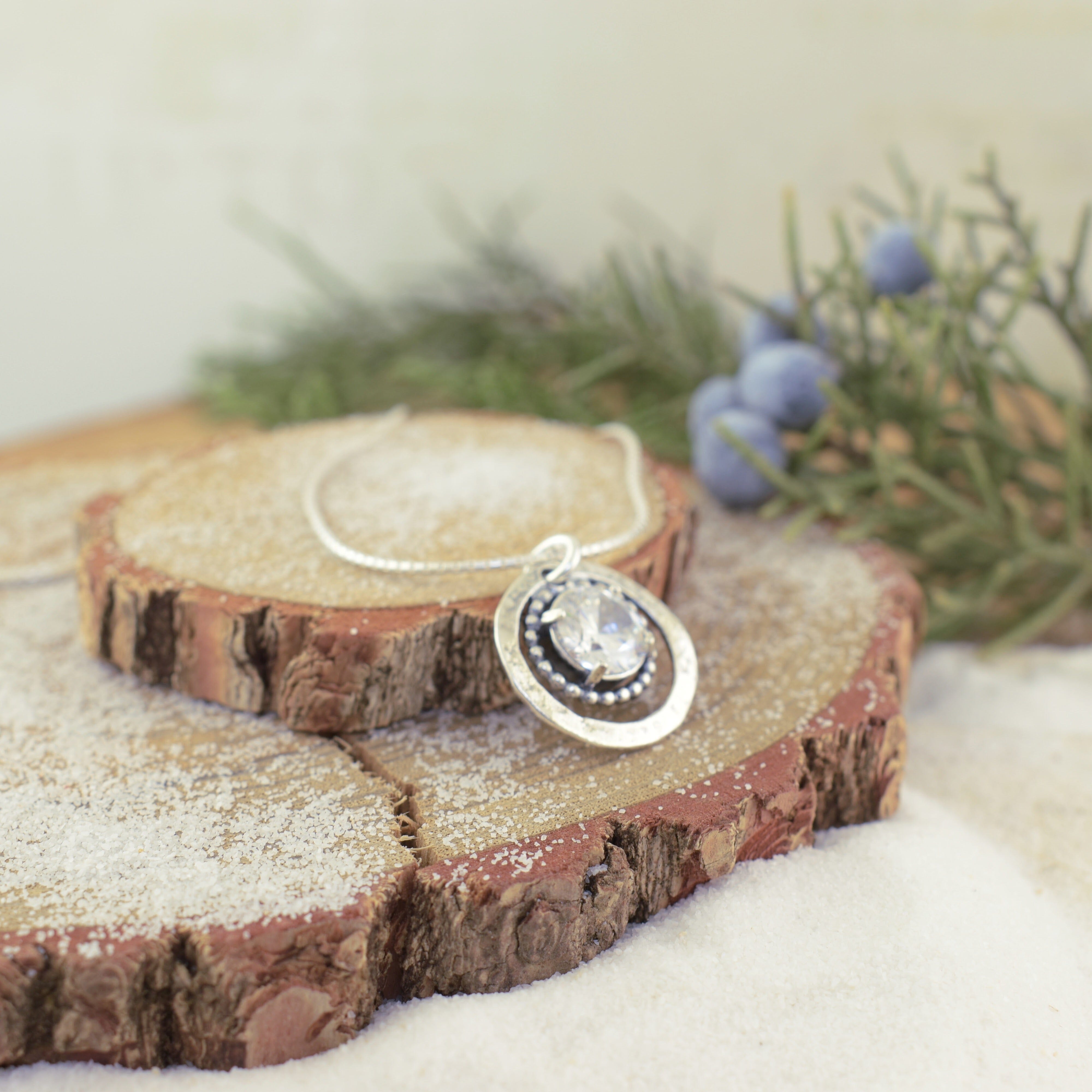 prong set CZ stone with a silver beaded ring around