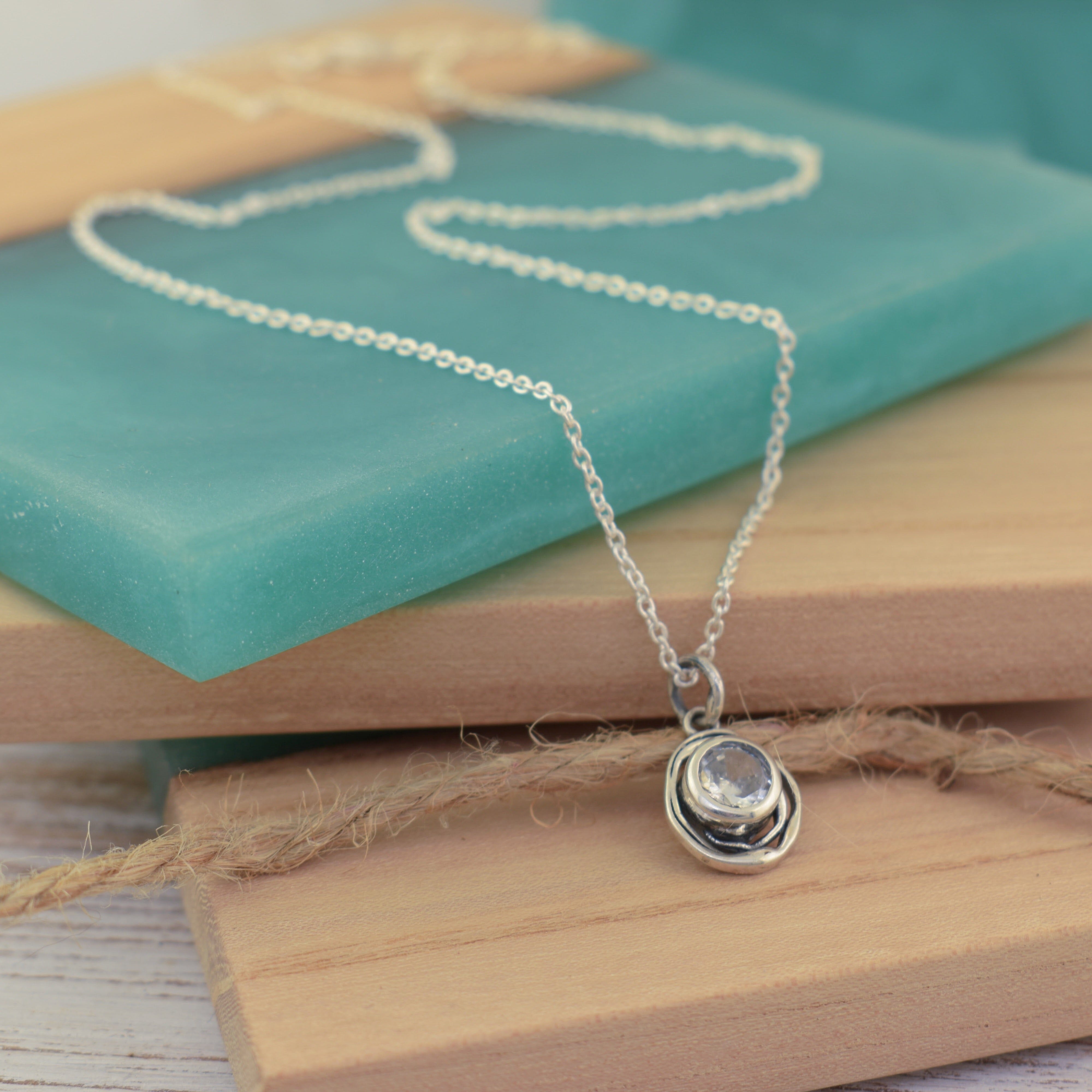 this piece features an organic swirl of silver wrapped around a sparkling center