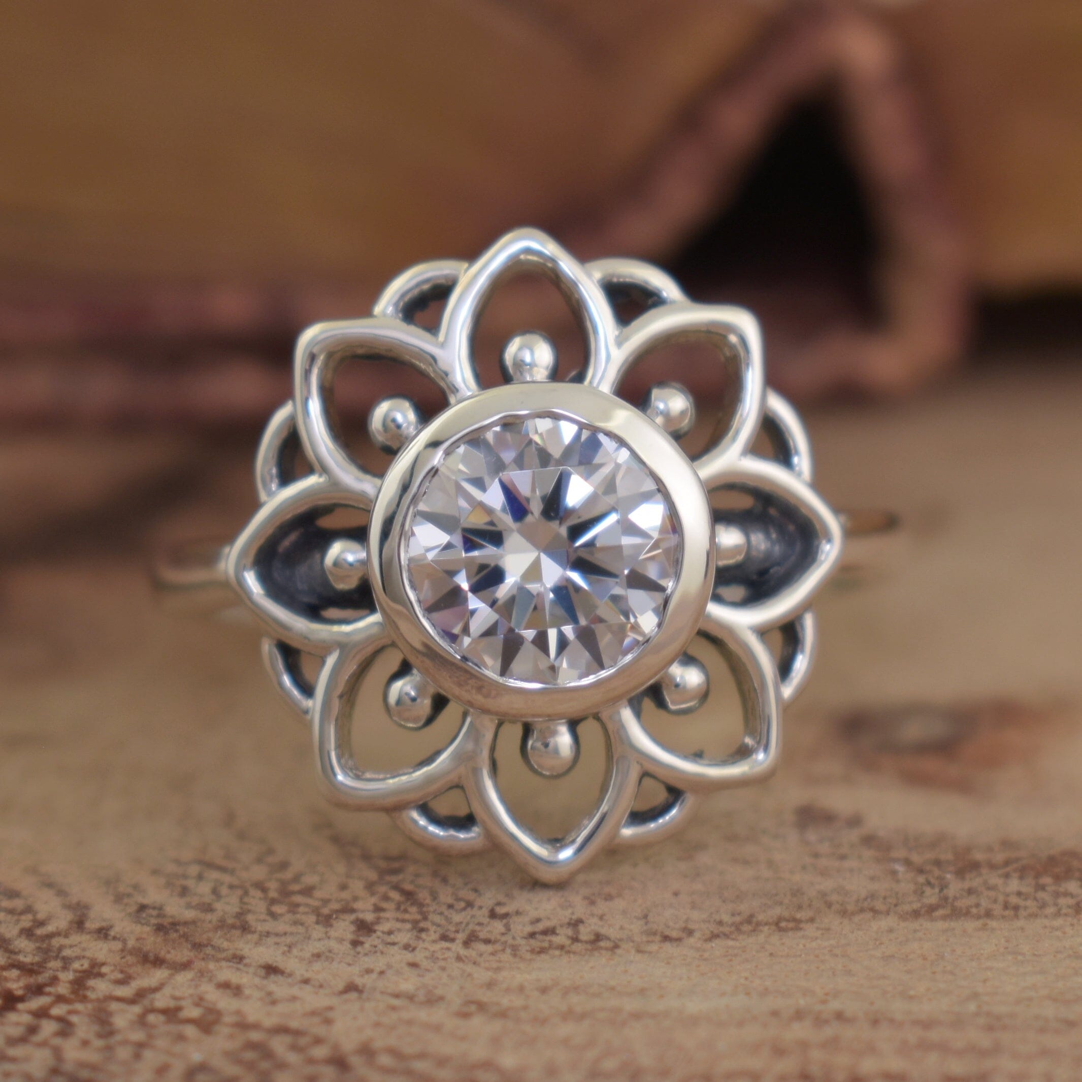 designer flower ring featuring round cubic zirconia bezel-set in sterling silver