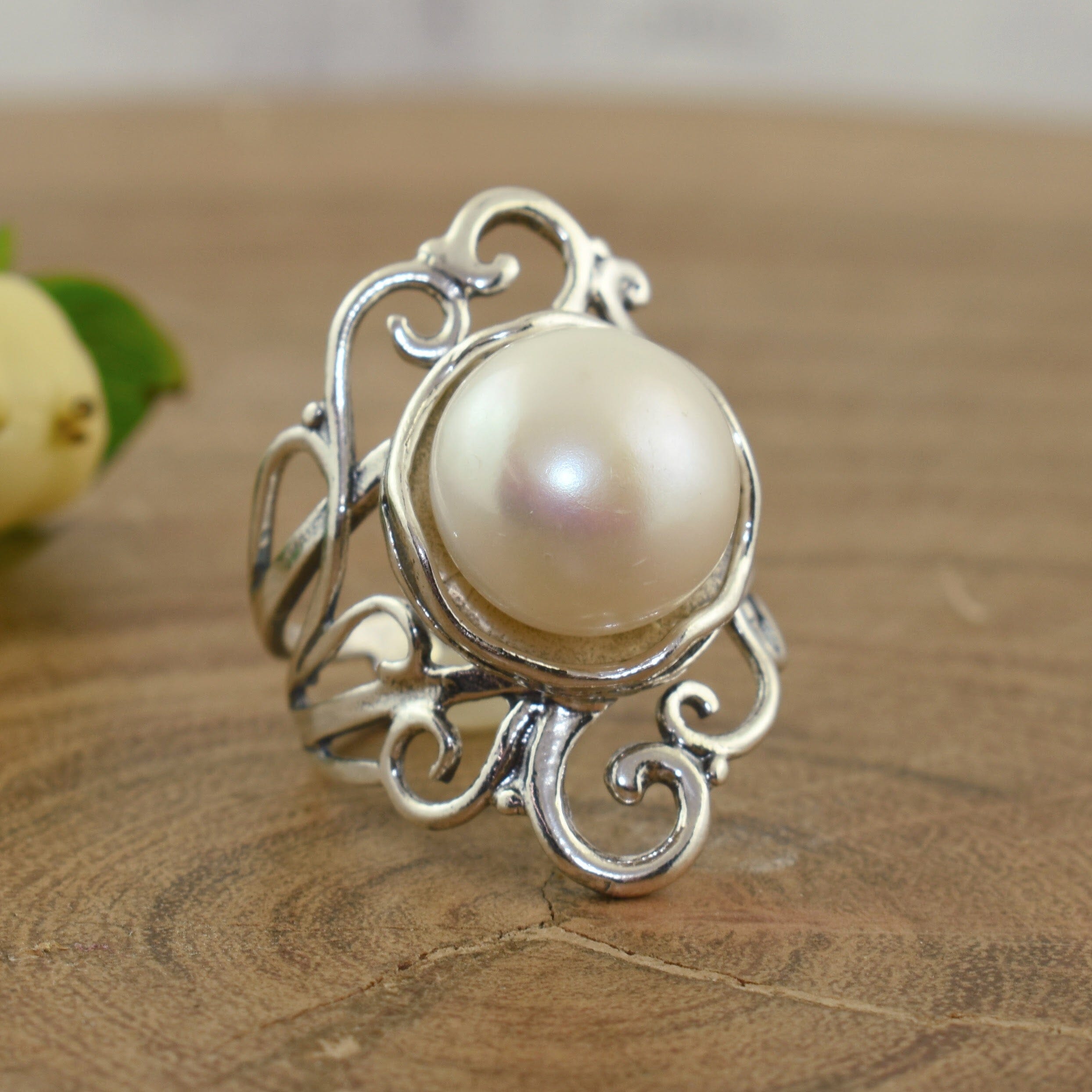 .925 sterling silver ring with swirl accents and featuring a sizable freshwater pearl