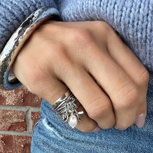 wide silver pinky ring with three dangling charms