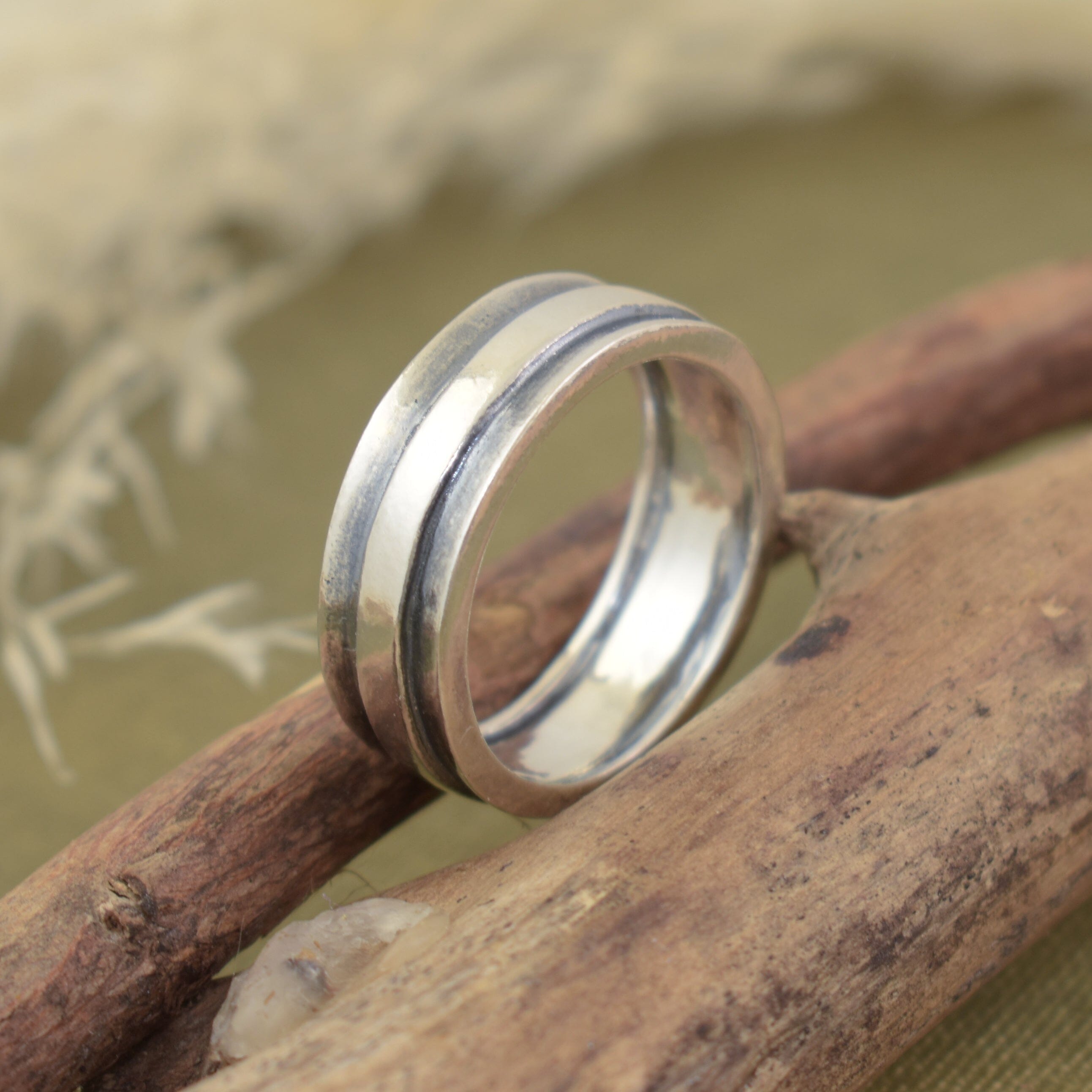 minimalist style sterling silver band with a high polished and oxidized finish