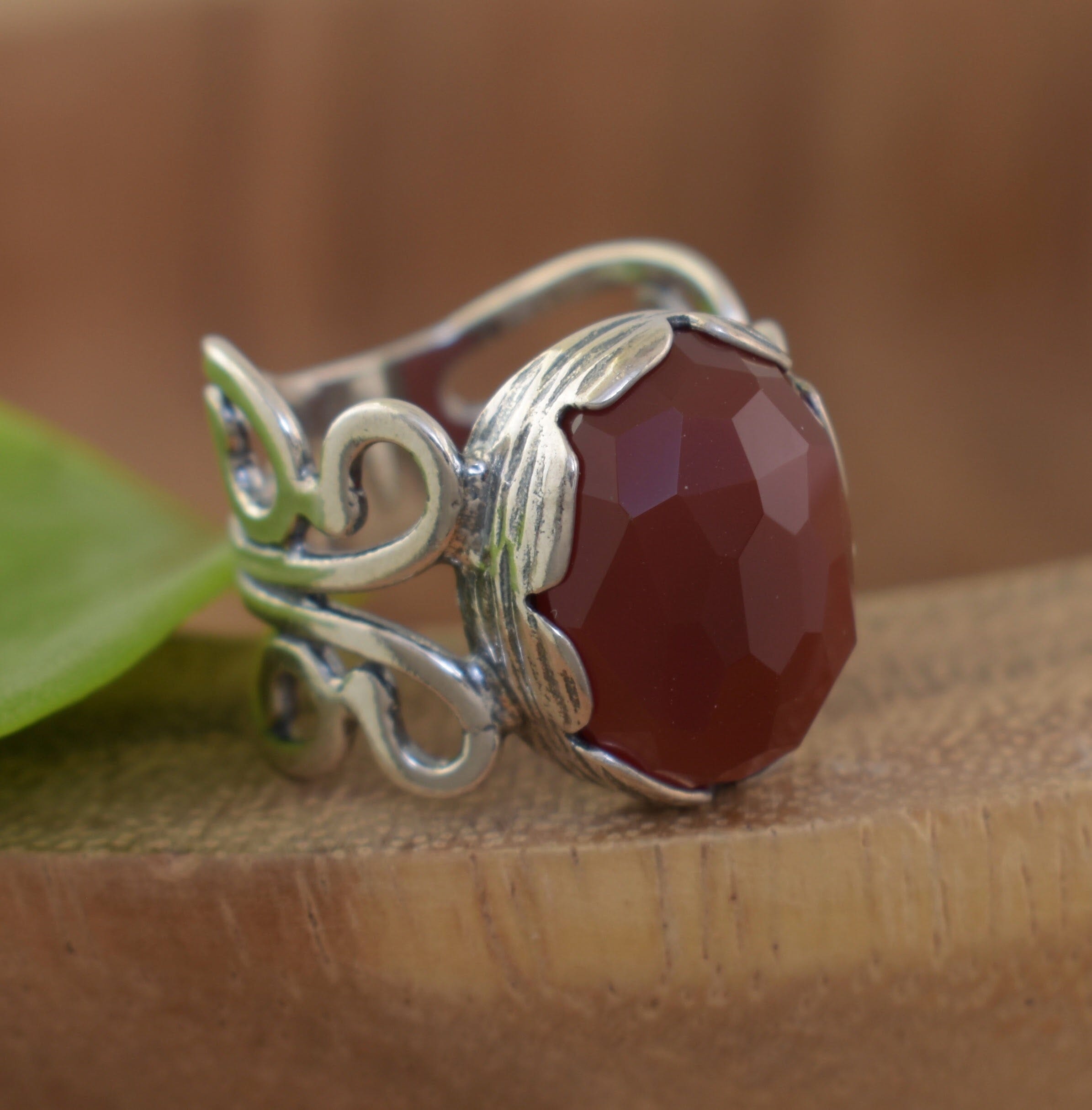 Designer stering silver swirl ring with large red stone